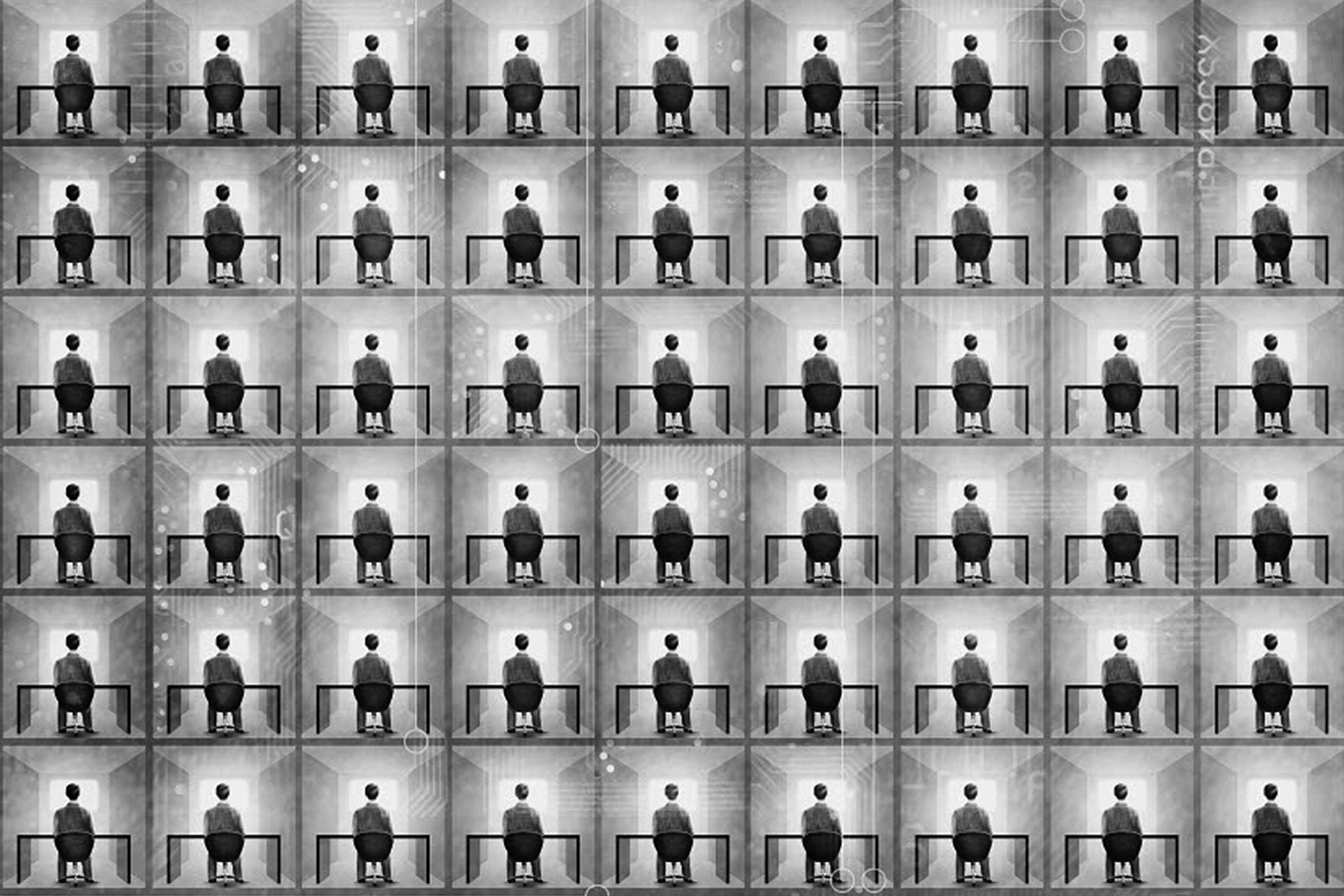 Person sitting at a desk in a black and white grid