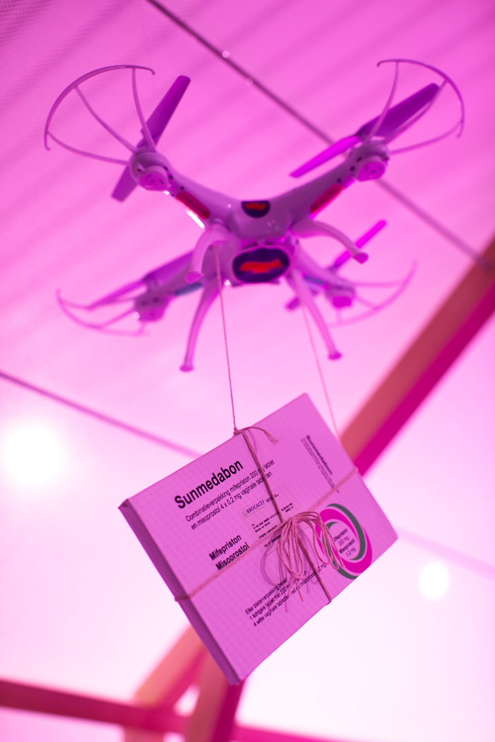 Birth control pills attached to a drone.