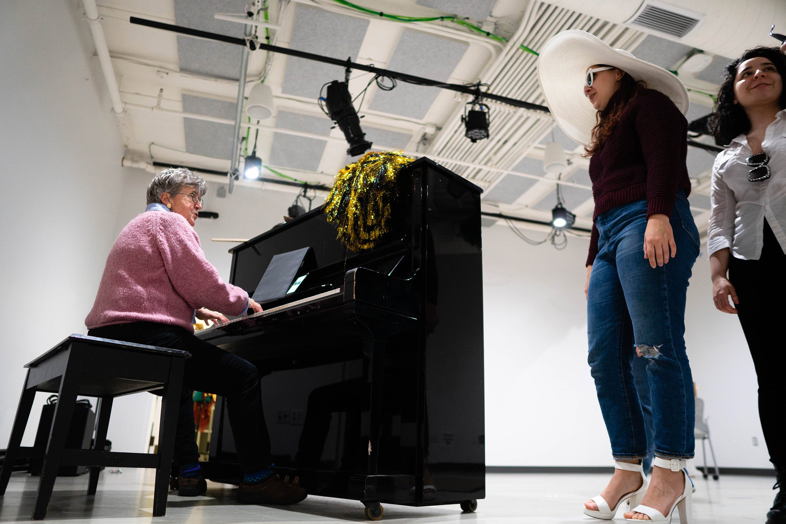 Musical director Catherine Stornetta plays piano and runs performers through vocal warm-ups before rehearsal.