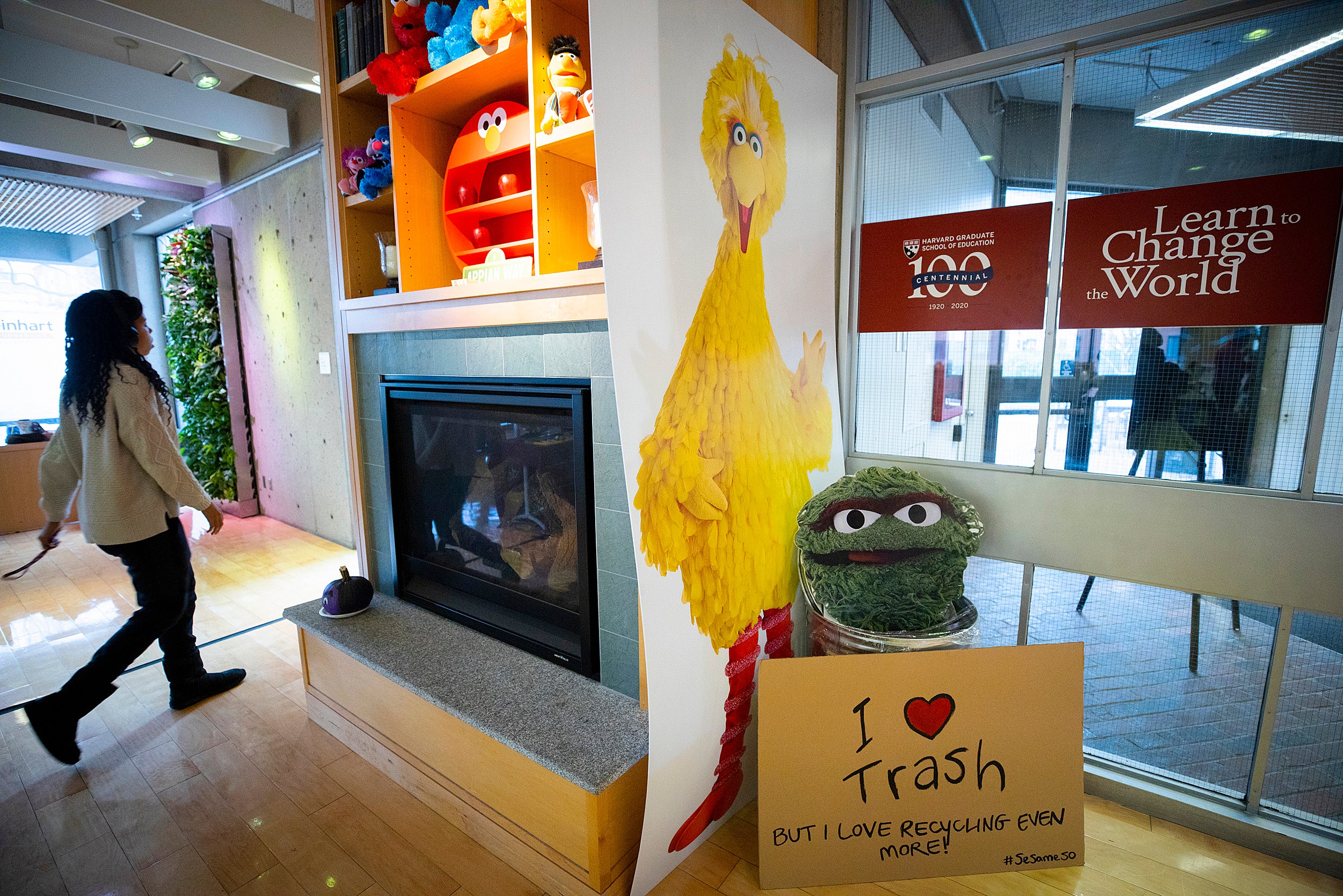 Shelving over a fireplace at the Ed School is lined with Sesame Street toys.