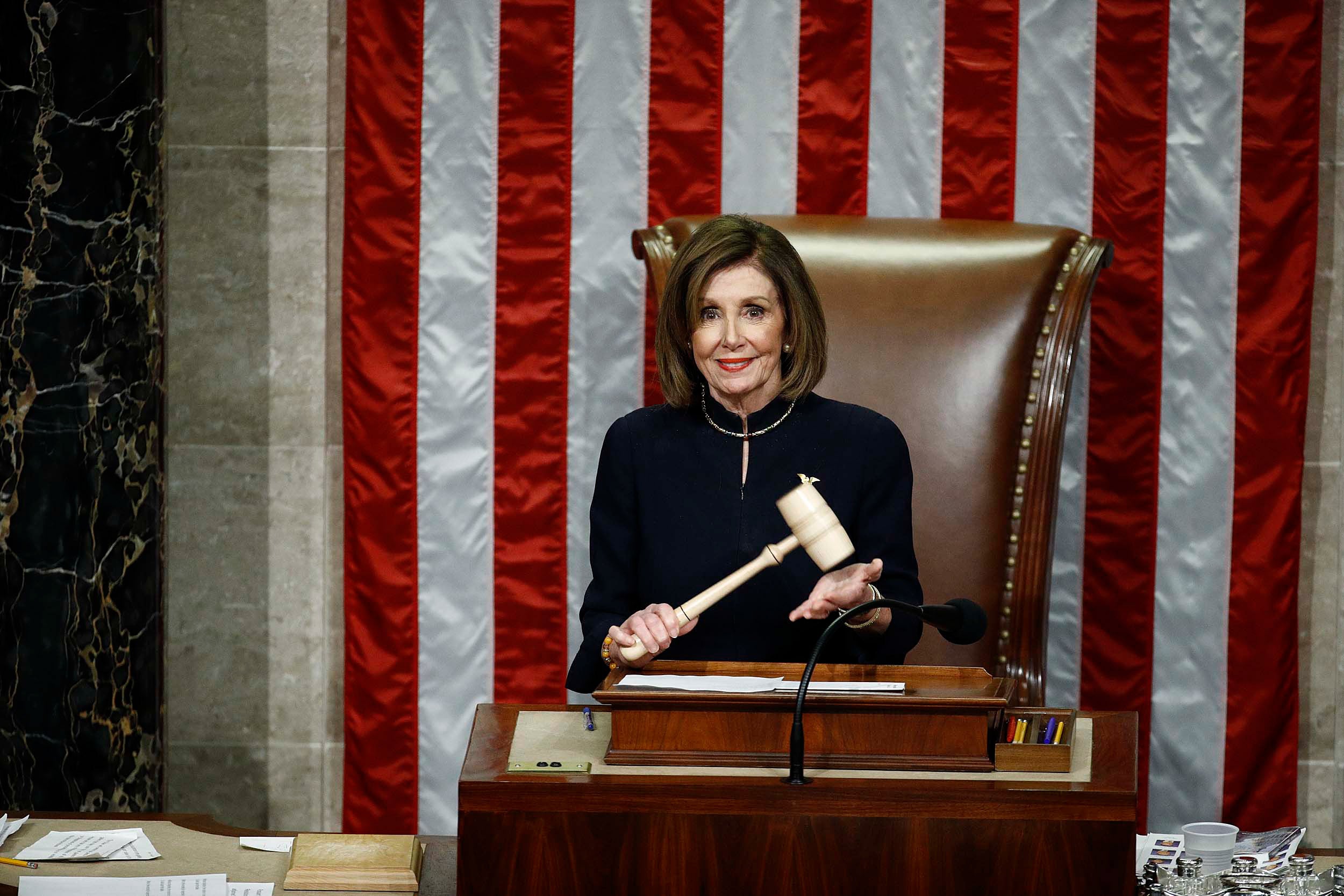 House Speaker Nancy Pelosi holds the gavel.