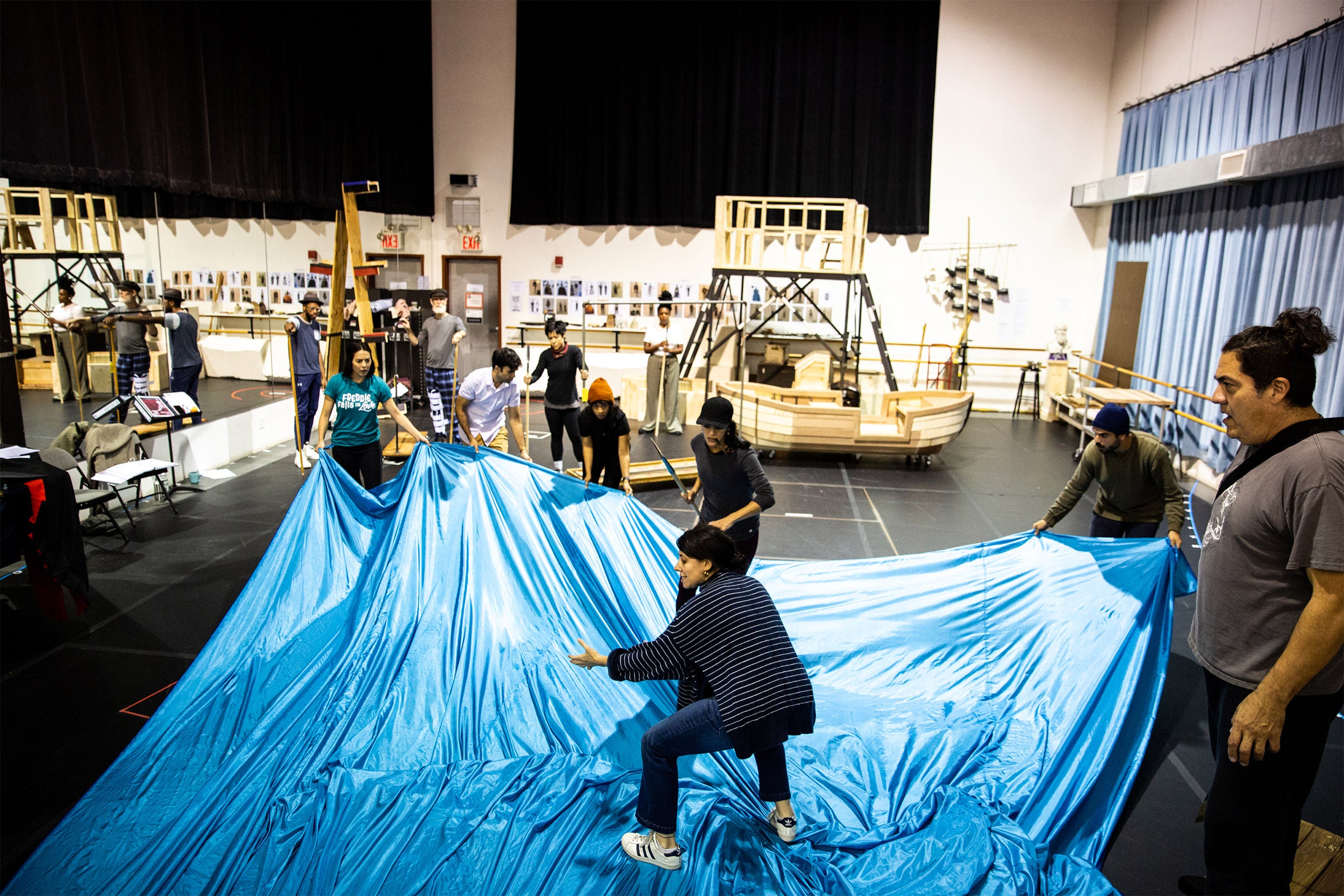 The cast rehearses in the studio, using a large blue sheet as the ocean.