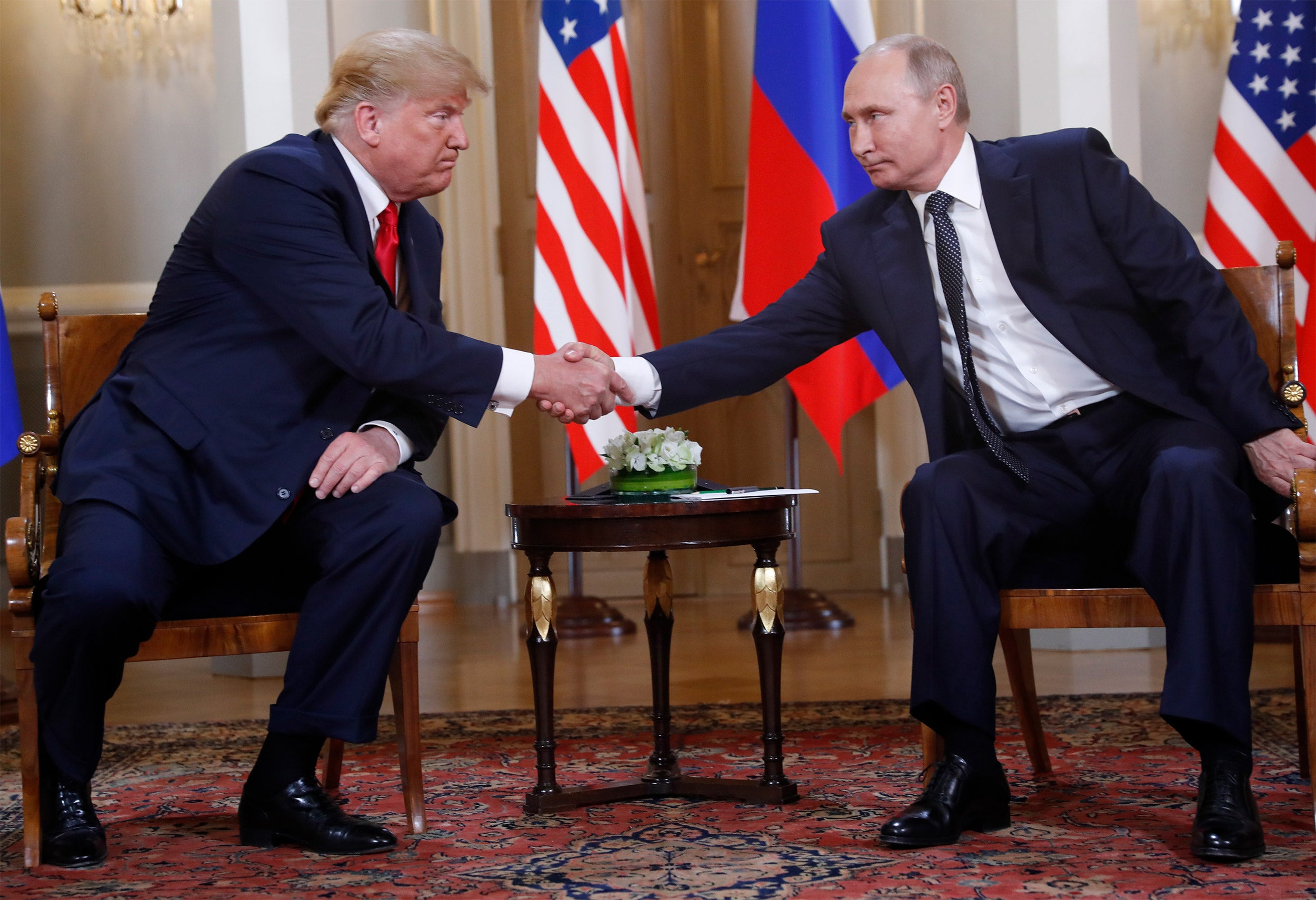 Trump and Putin shaking hands.