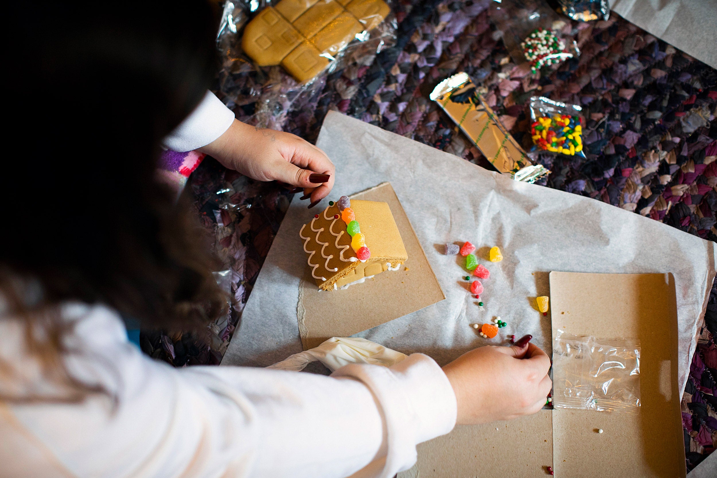 Decorating a gingerbread house.
