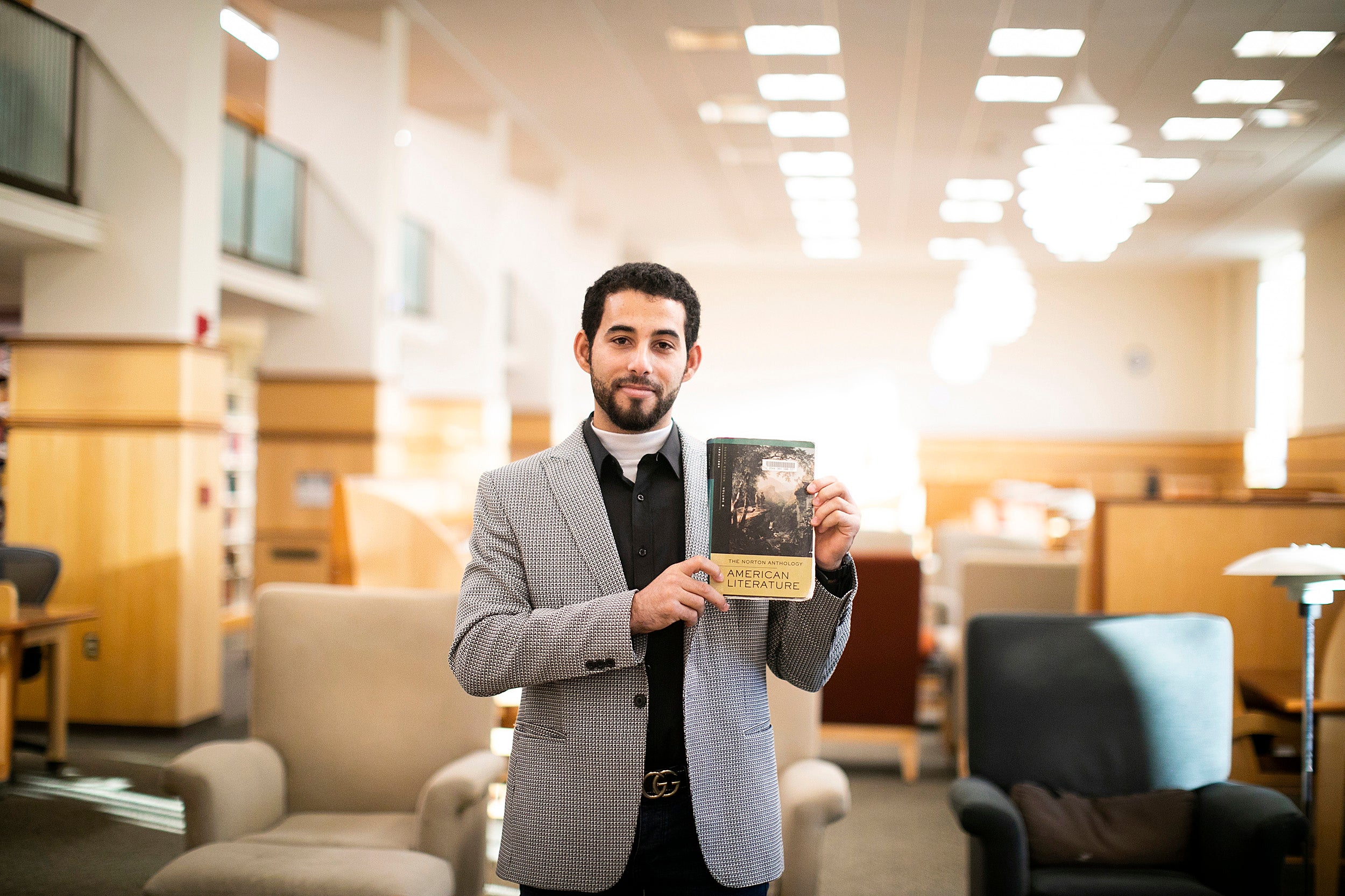 Mosab Abu Toha holding a book.