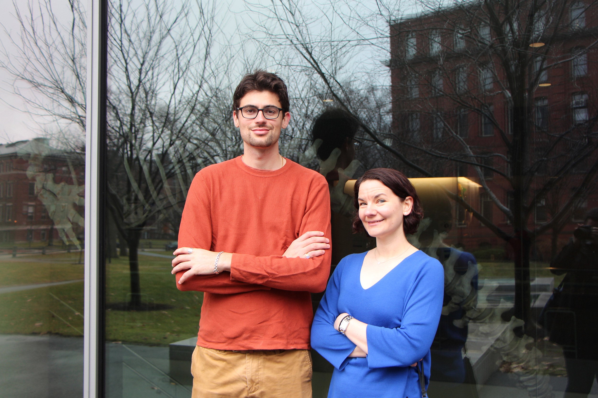 Two researchers standing in front of a building.