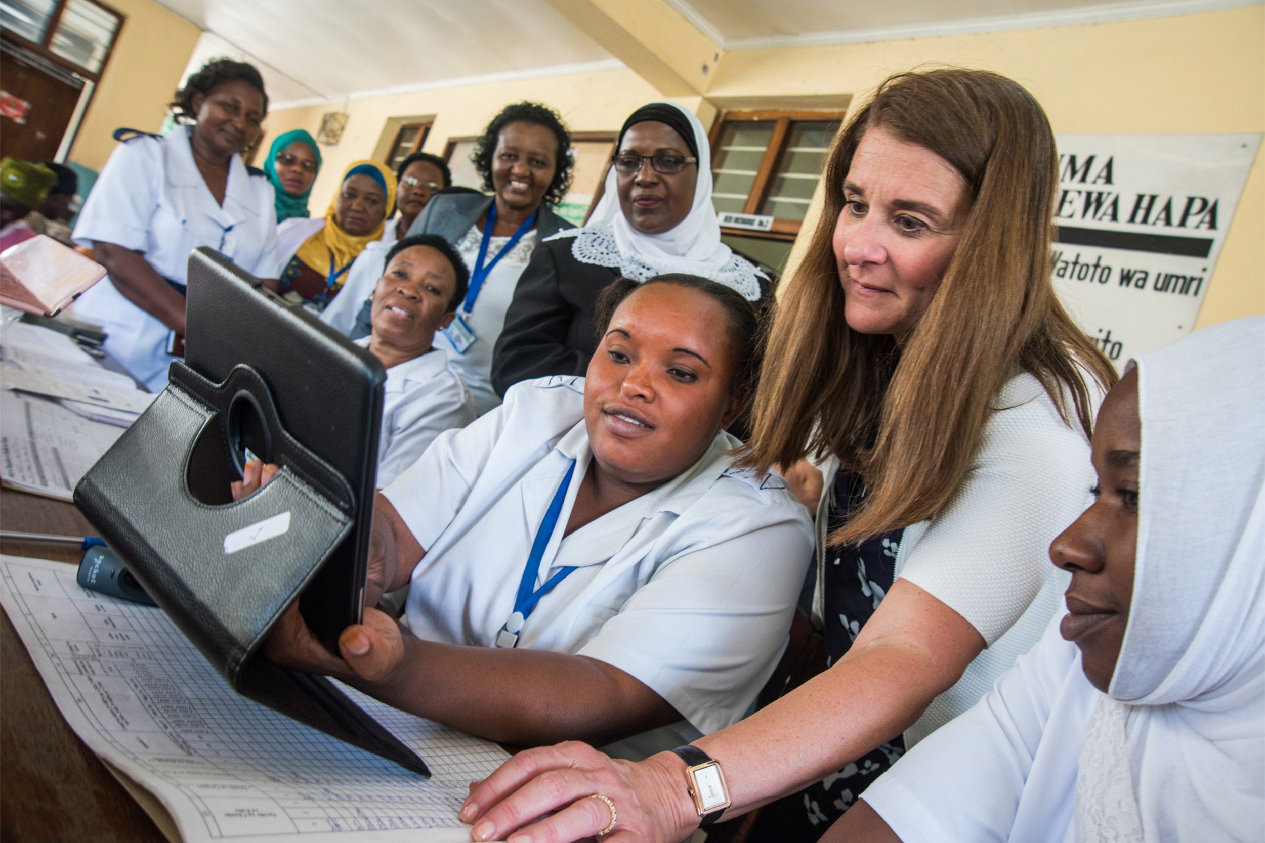 Melinda Gates looking at a computer with nurses in Tanzania.