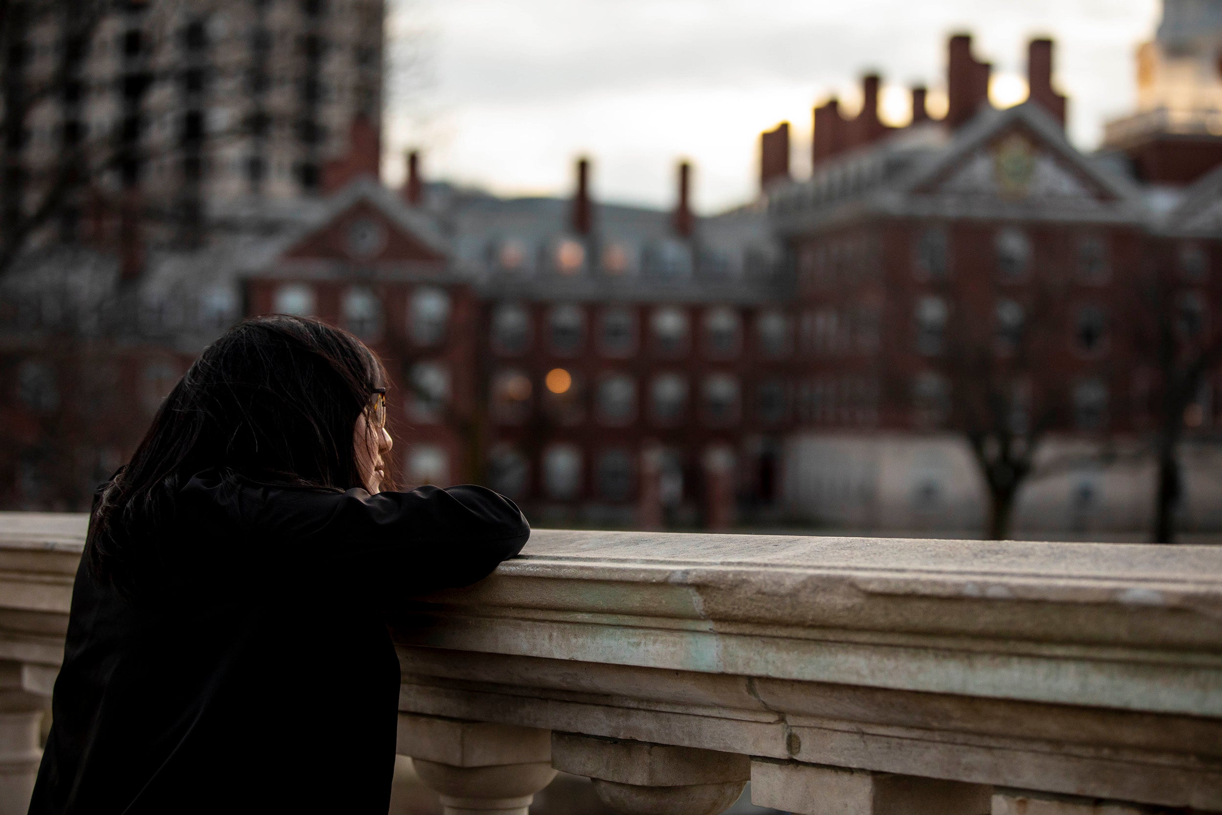 Student staring out over the Charles River.