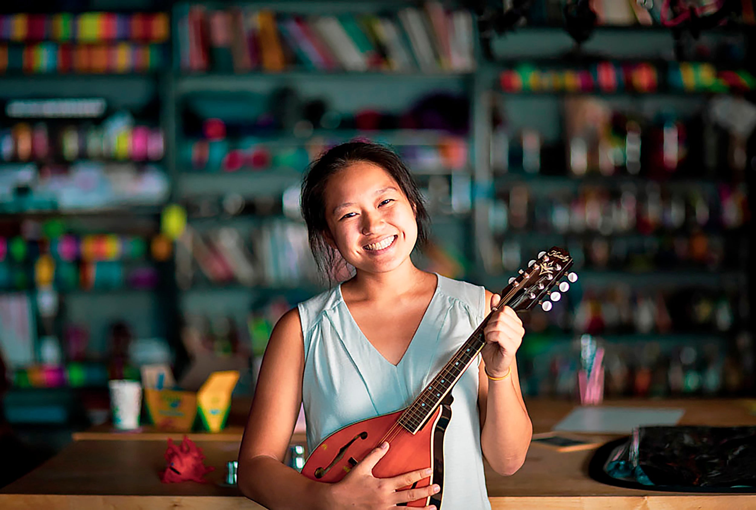 WHRB president Allison Pao ‘21, at the station with her mandolin.