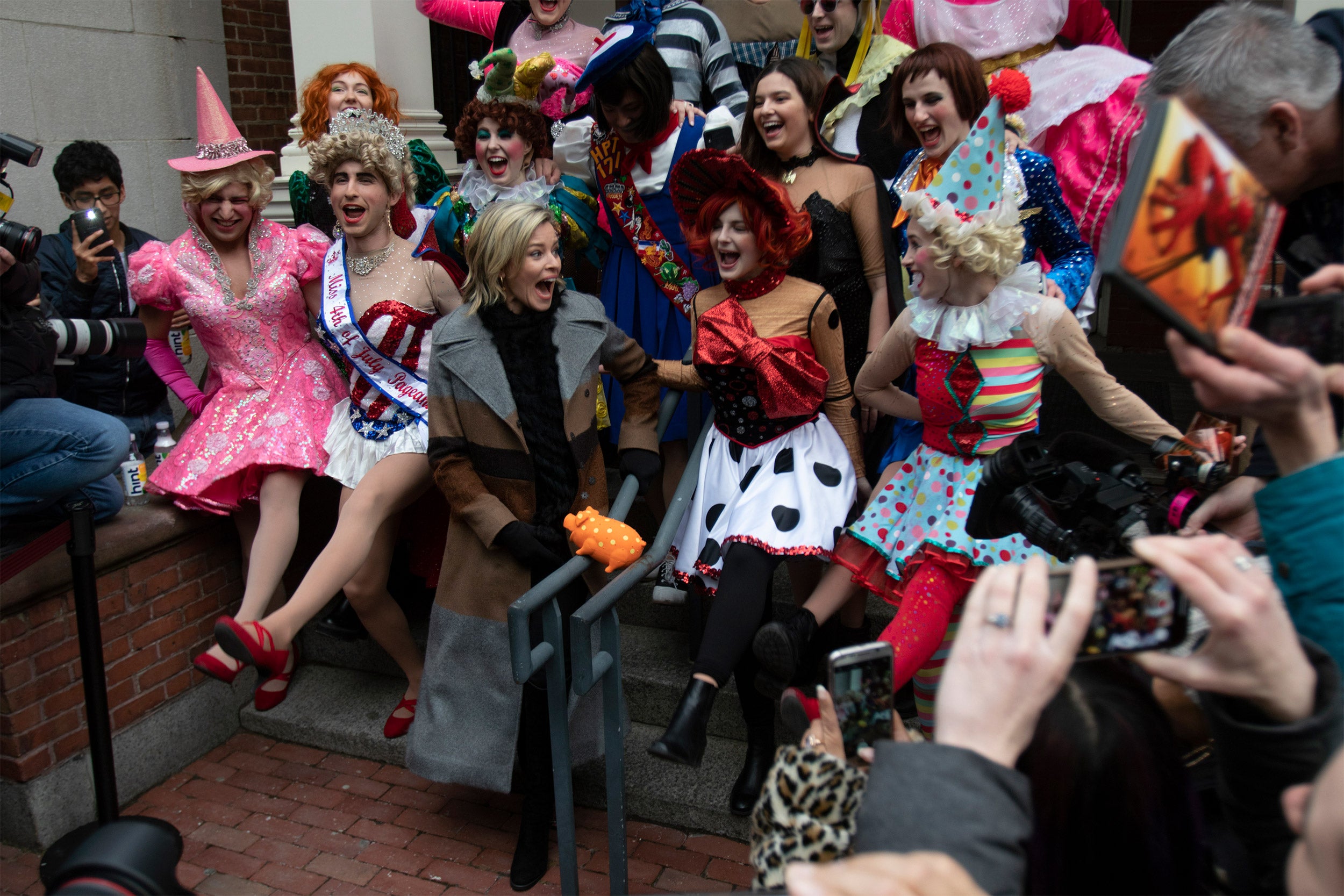 Elizabeth banks surrounded by colorful characters