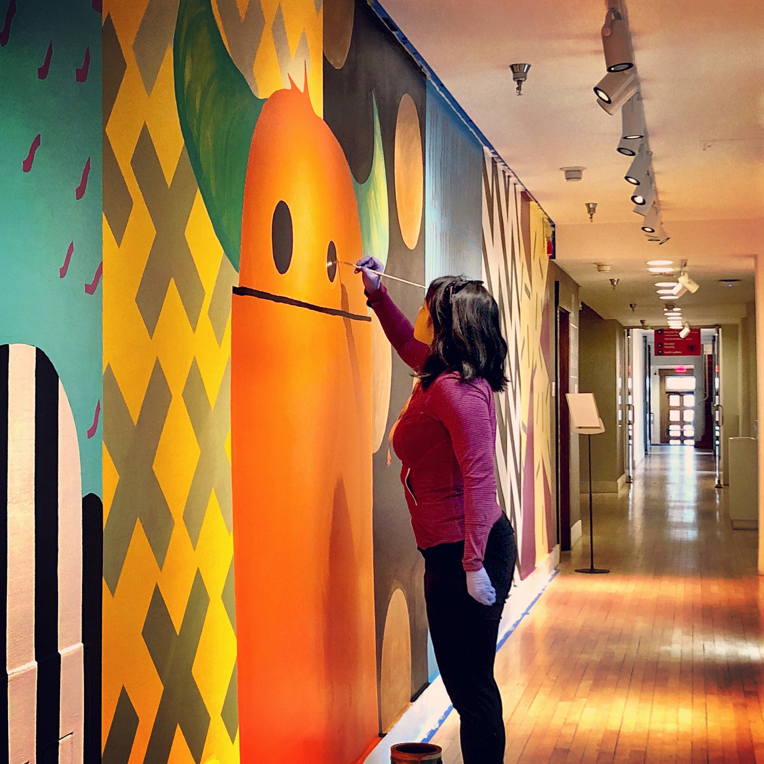 Heidi Brandow paints a mural at the Museum of Contemporary Native Arts in Santa Fe, New Mexico.