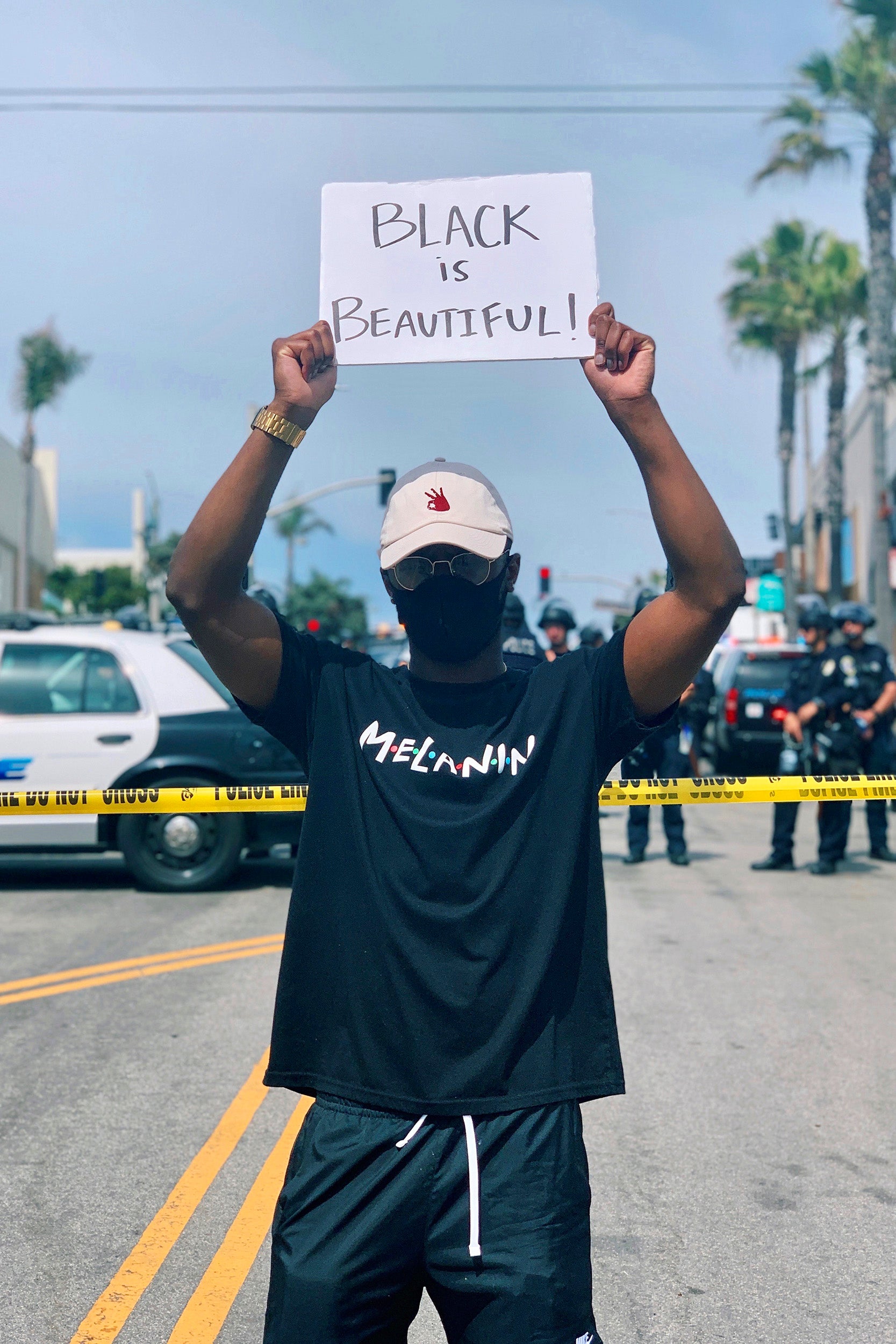 Elijah DeVaughn holds "Black is Beautiful" sign.