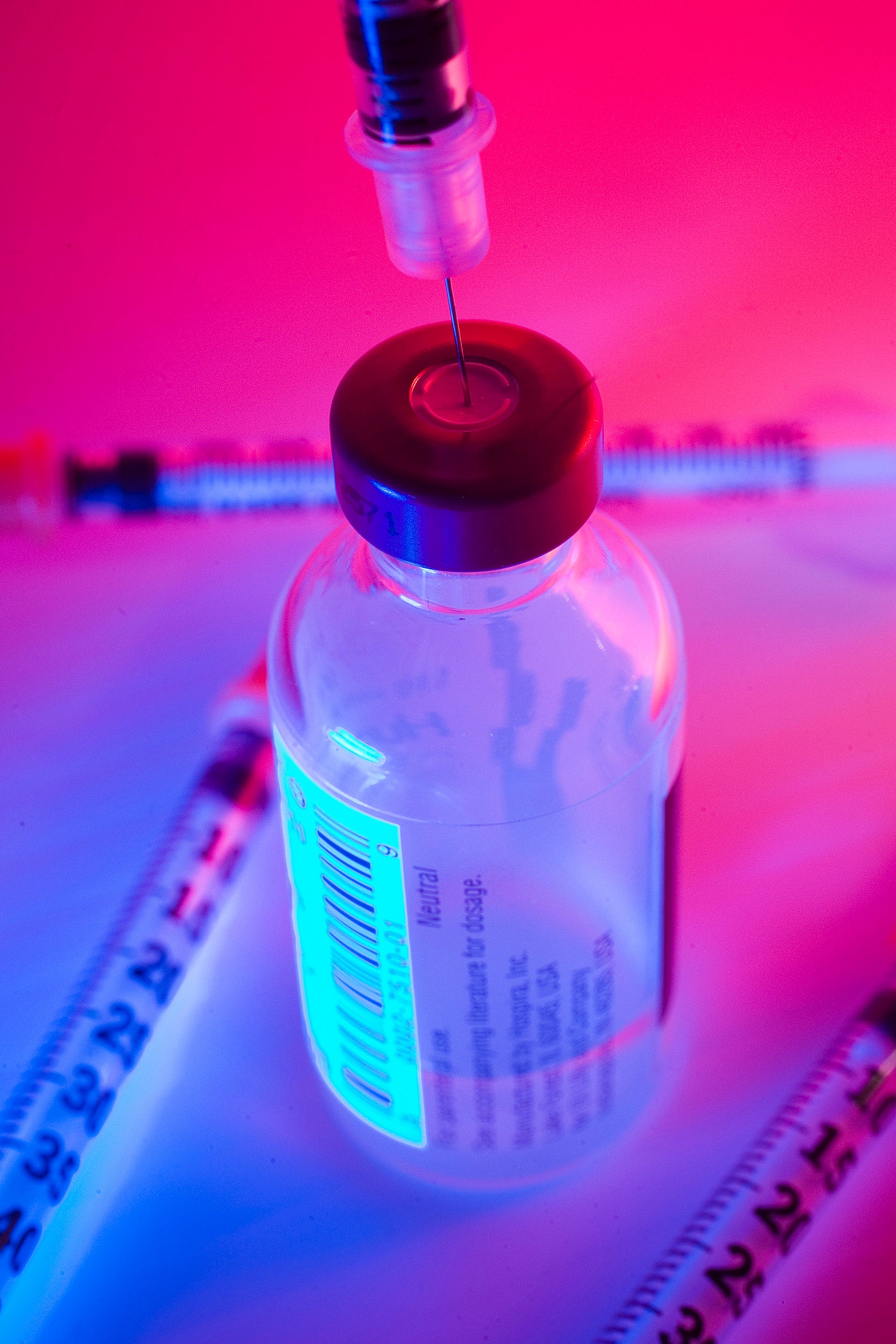 Syringe in vaccine bottle.