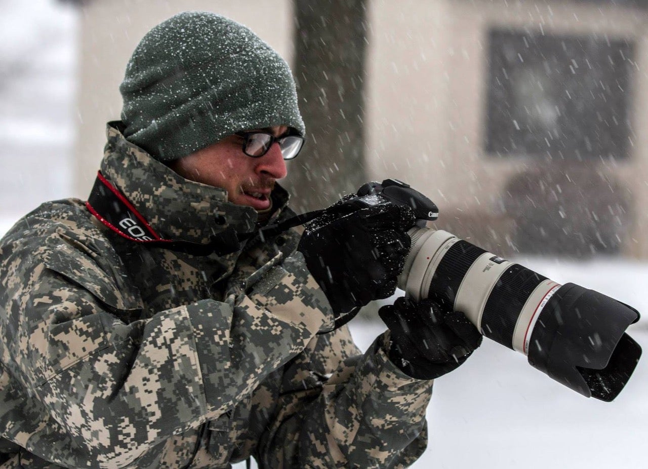 Kenneth Tucceri holding a camera in snow