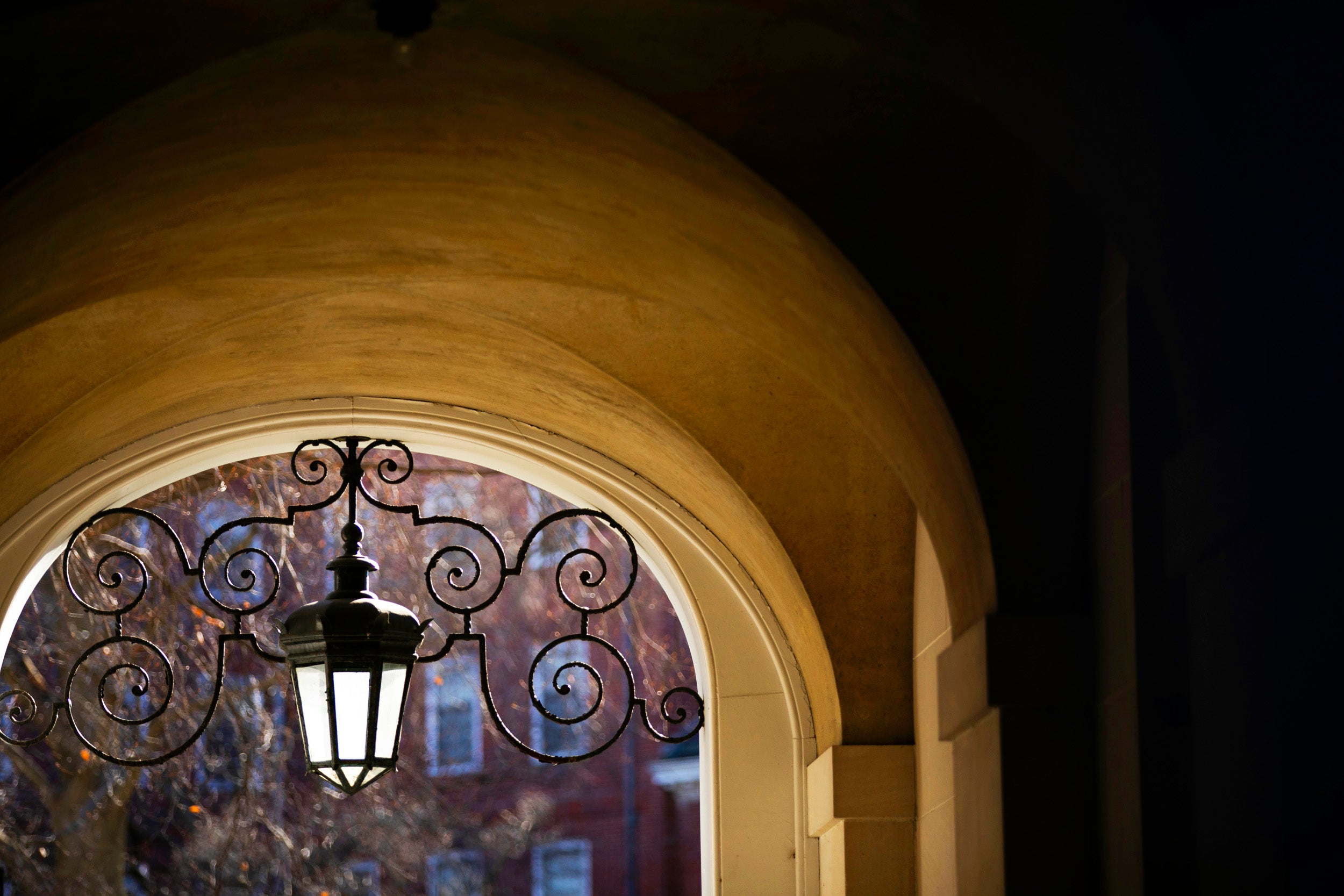 An elaborate lamp is pictured in the archway of Eliot House.