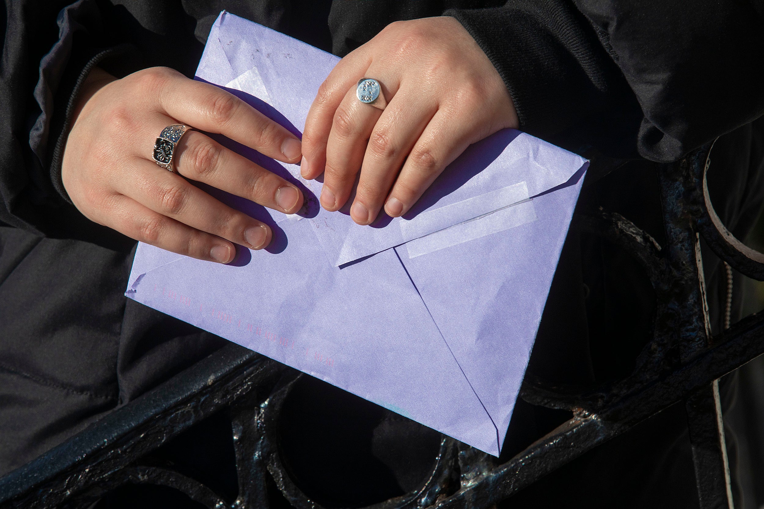 Two hands holding an envelope.