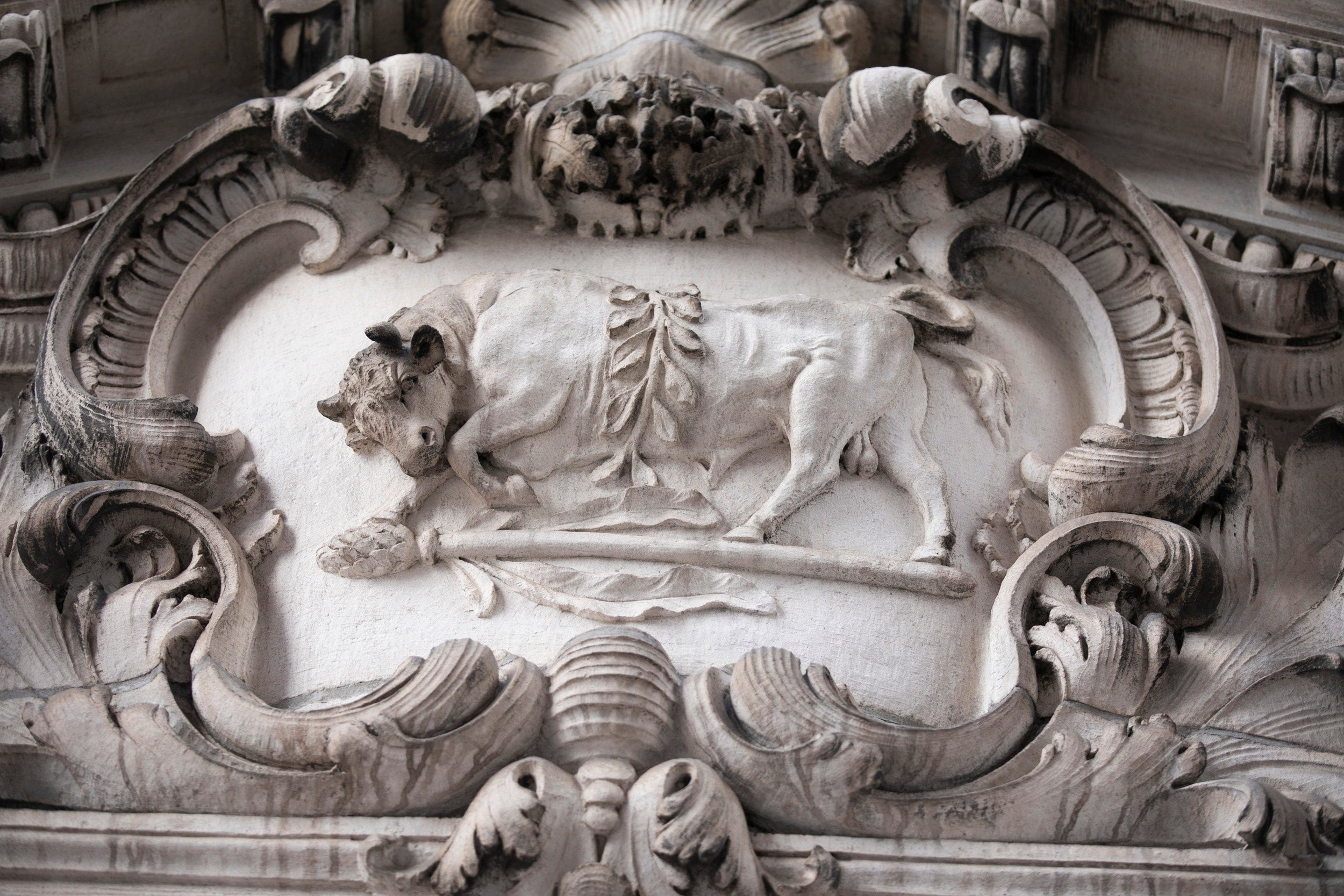 A bull is carved in marble.