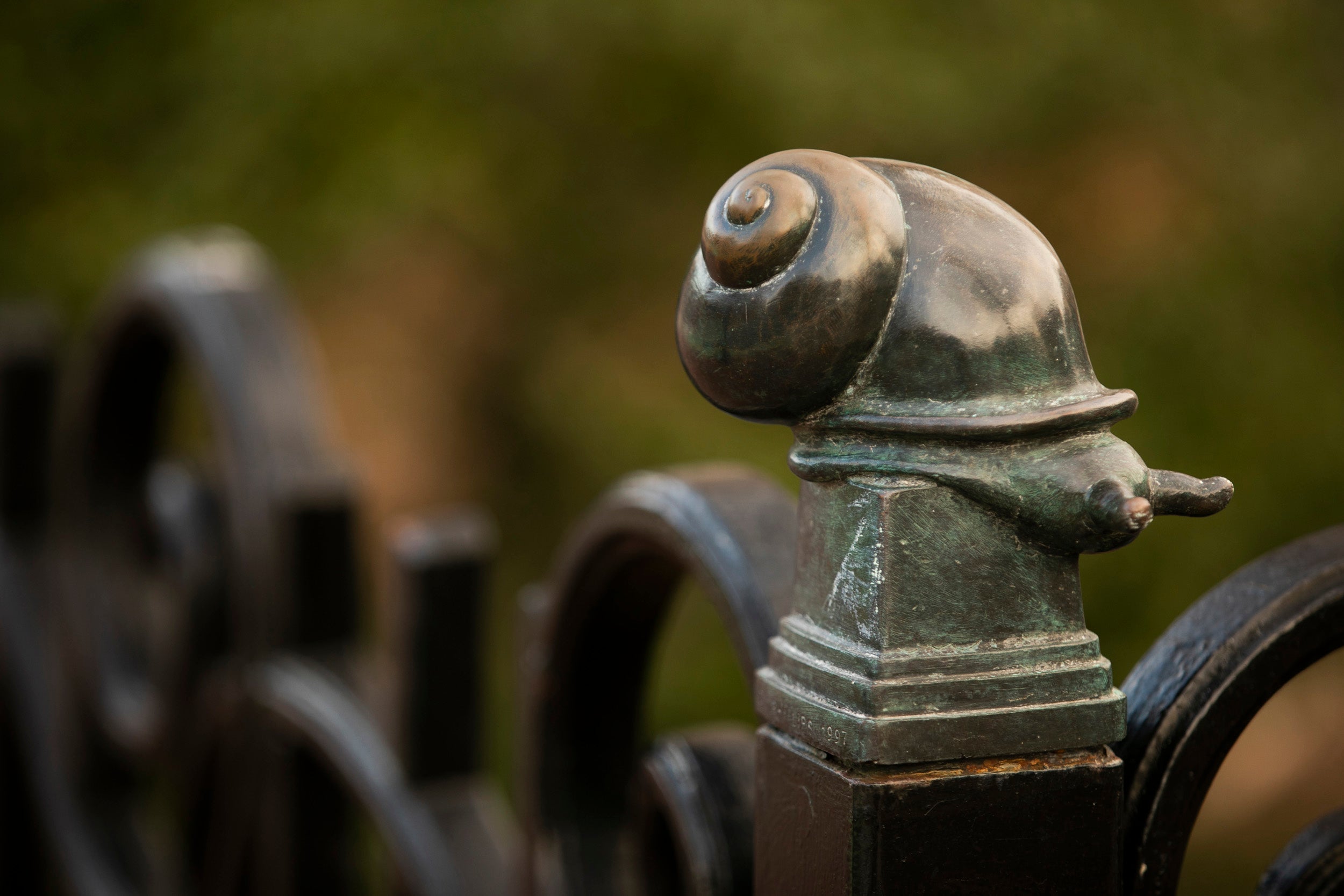 A snail decorates a fence in Quincy Square.