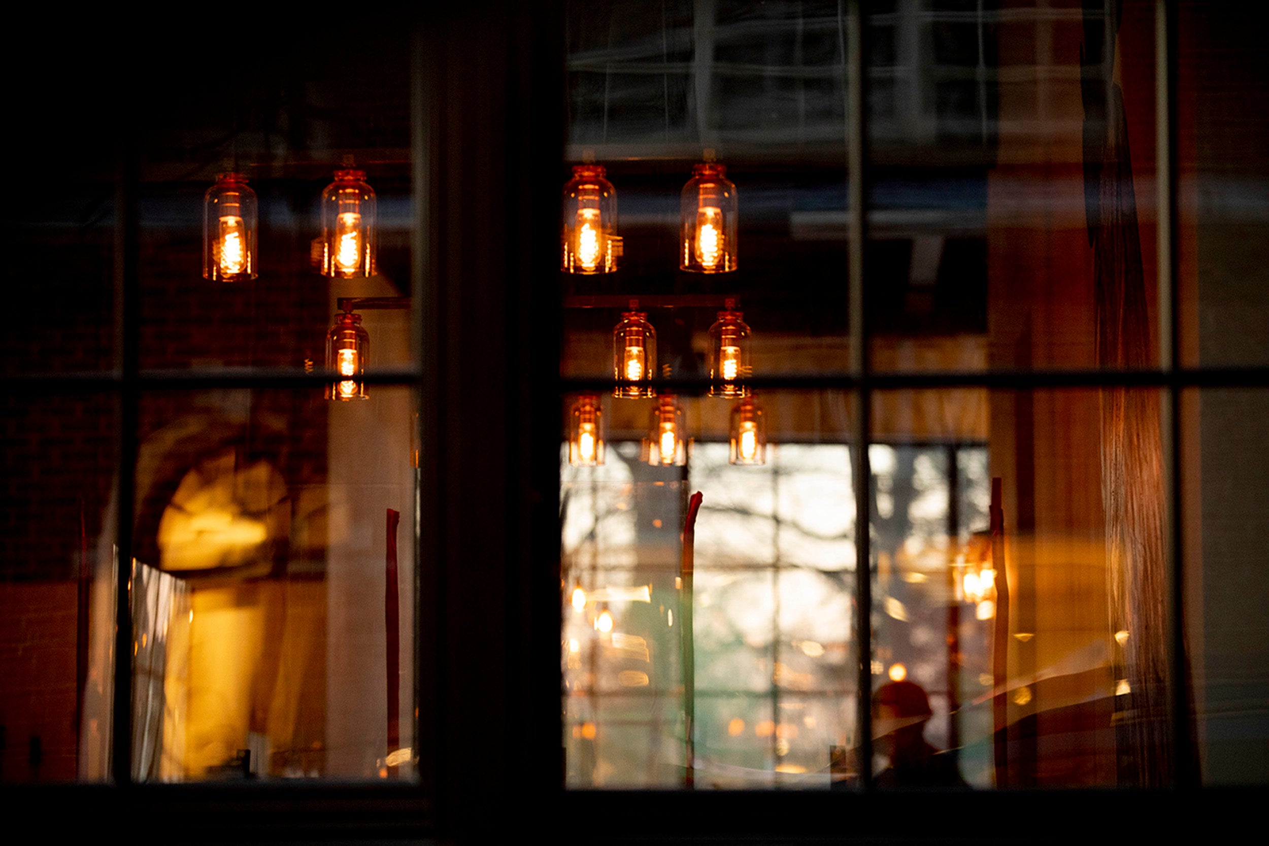 A patron watches tv inside Source a new restaurant on Church Street in Harvard Square.
