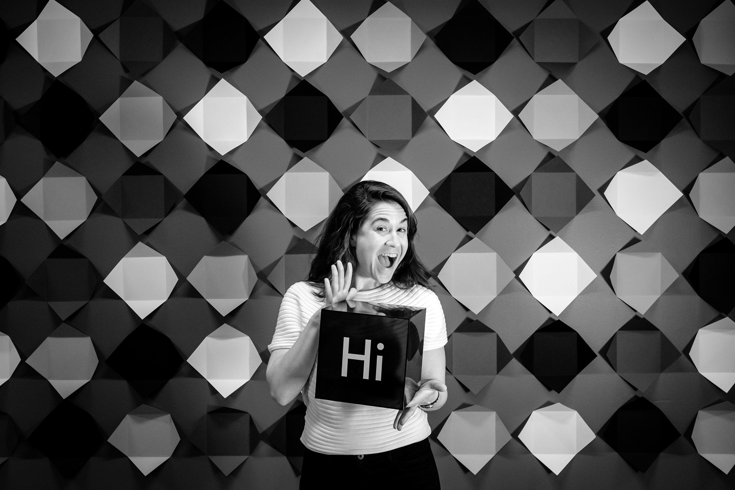 Laura Kelley holding a Hi sign.