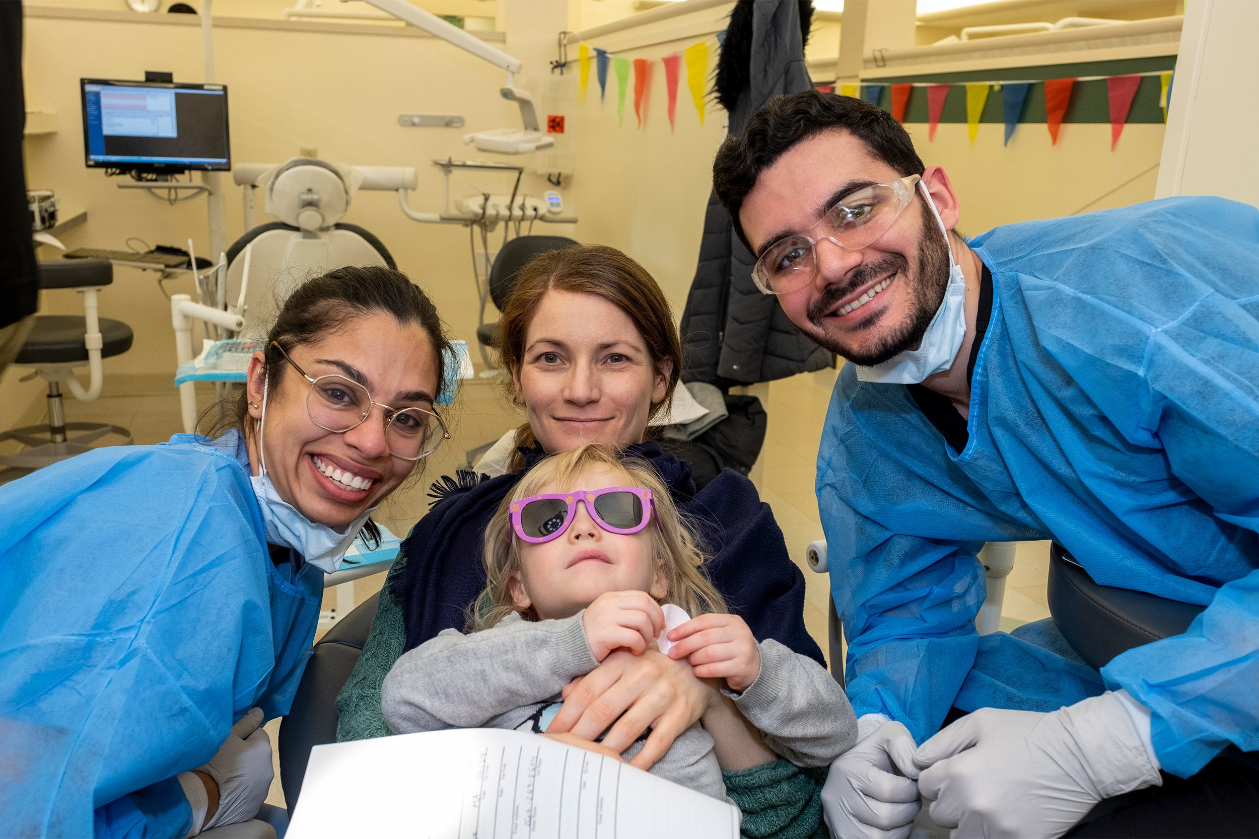 Ashiana Jivraj with other Dental School students and a young patient.