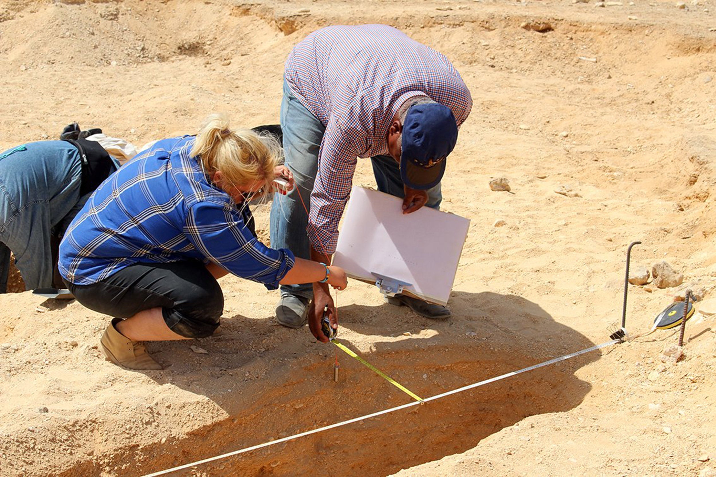 Two people at an archaeology site.