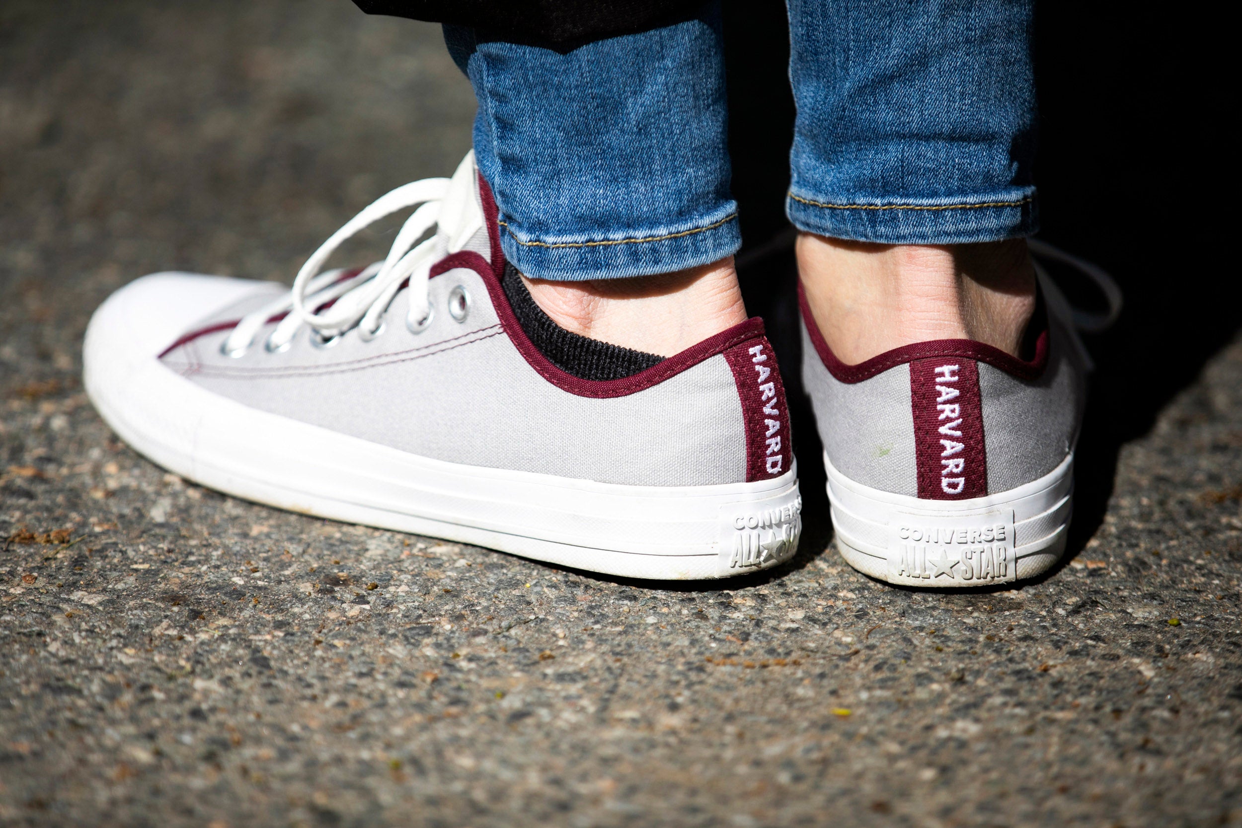 Converse sneakers that read Harvard along the back.