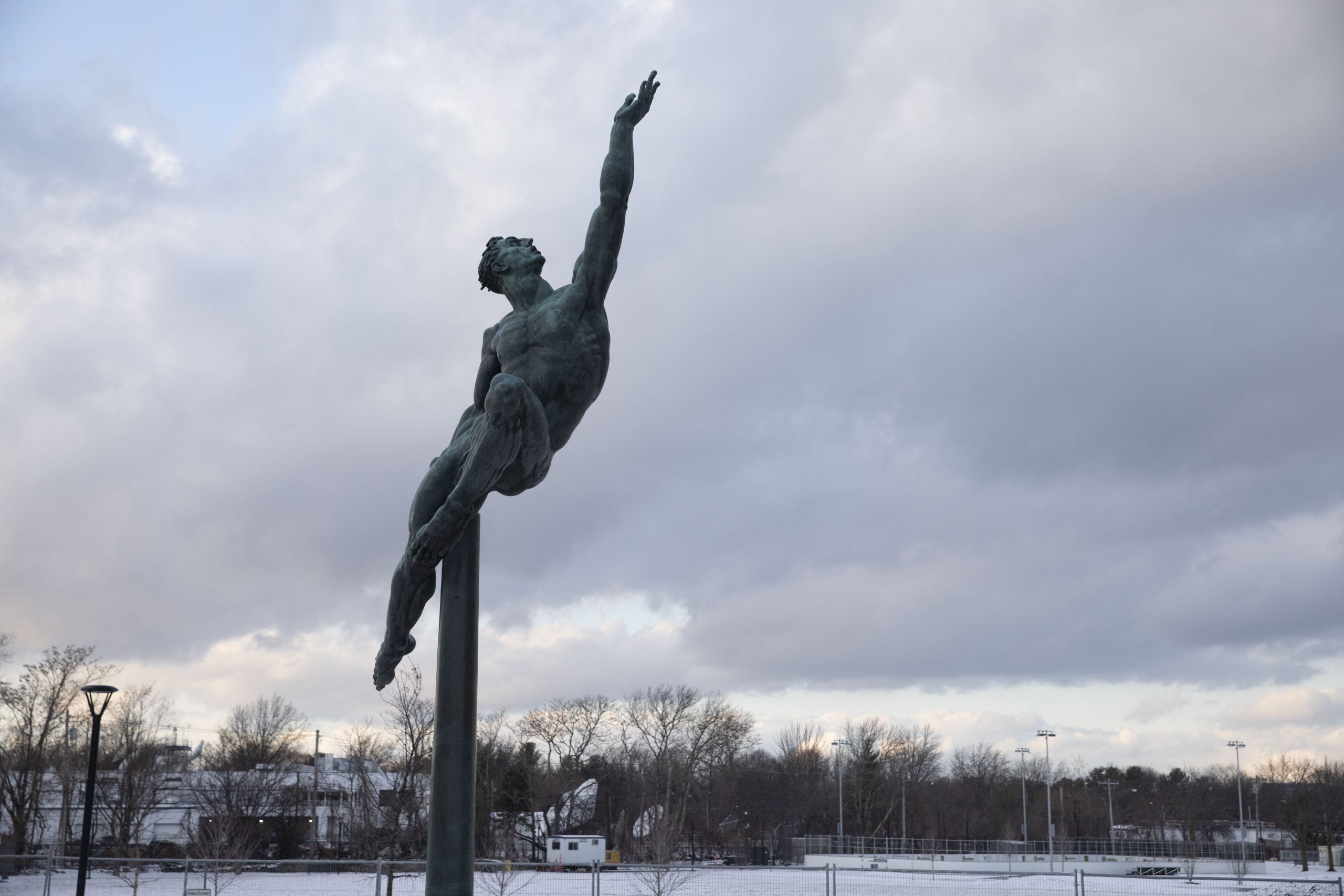 A statue of someone leaping and reaching to the heavens.