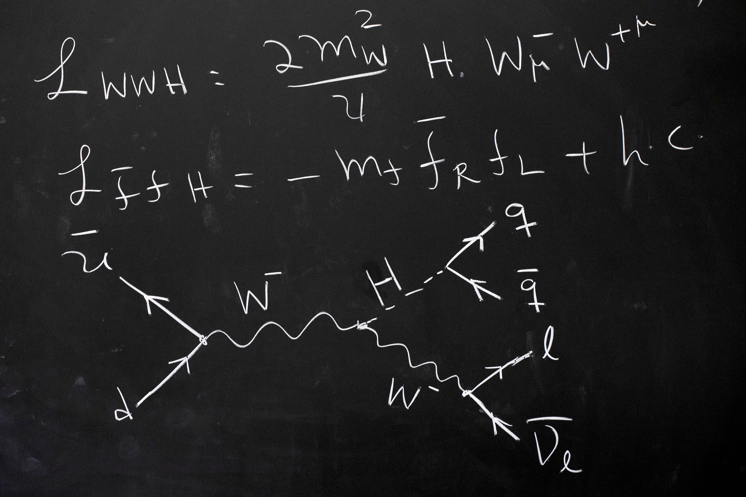 Equations on chalkboard.
