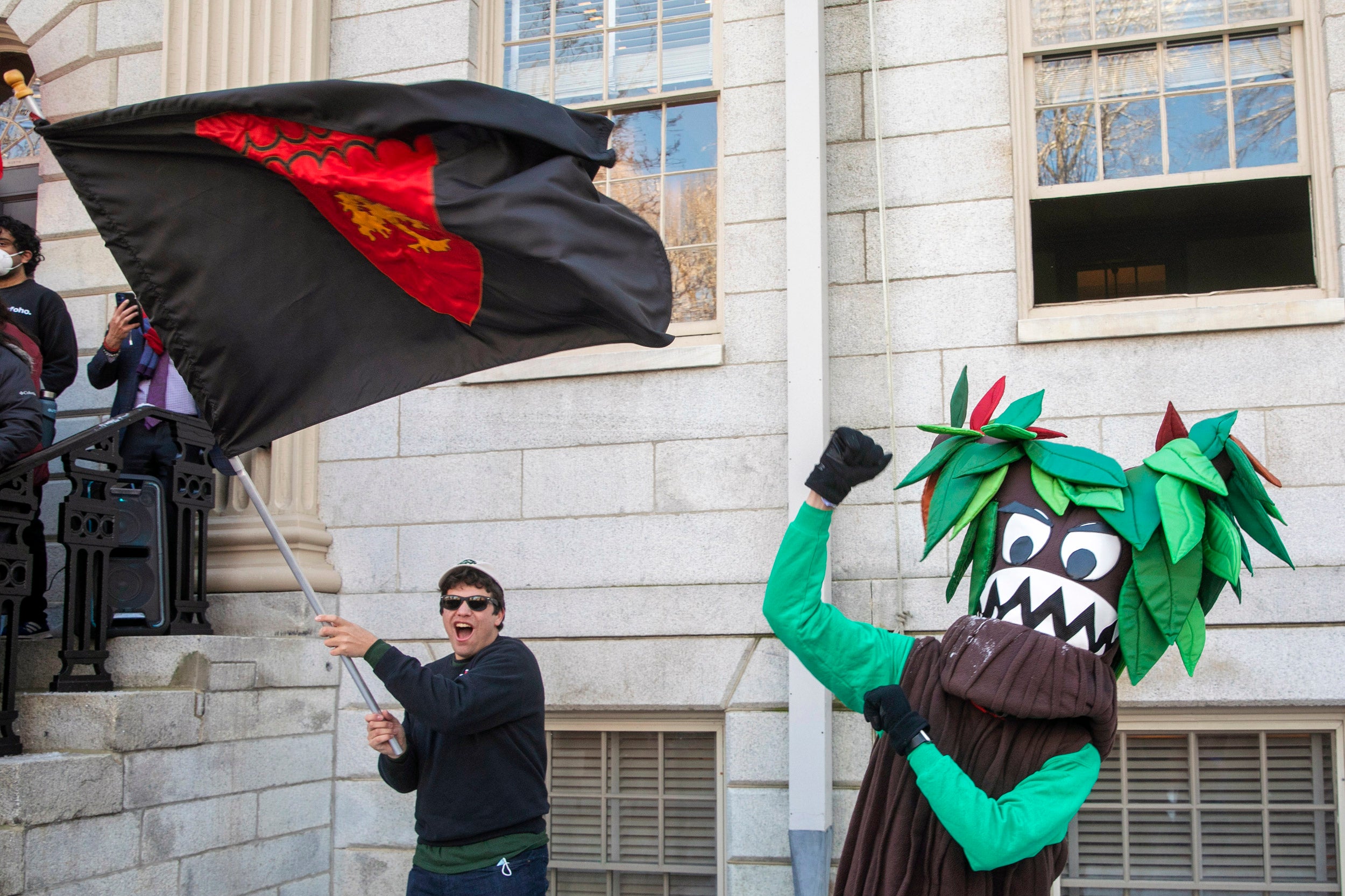 A Currier House flag waver and tree mascot celebrate.
