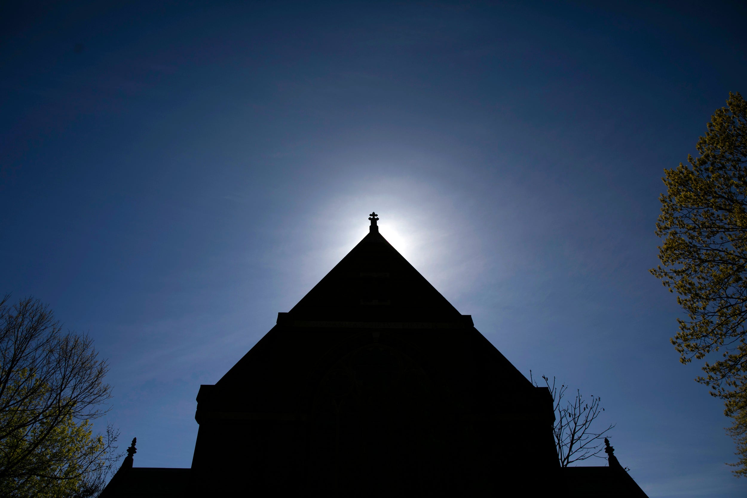 Memorial Hall is silhouetted by the rising sun.