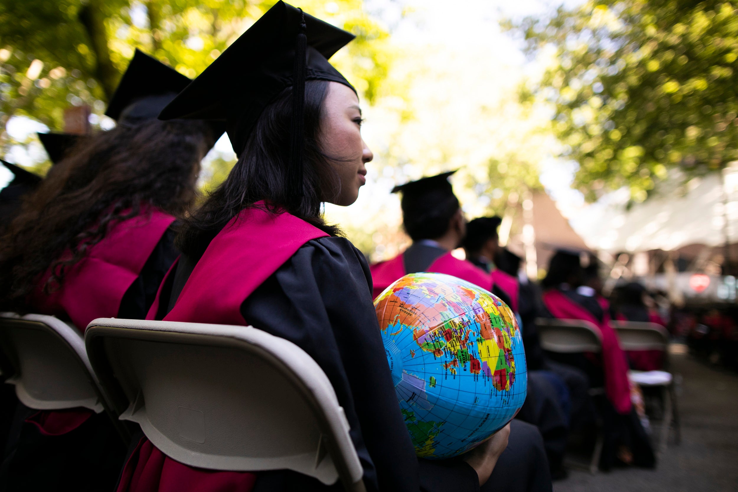 Jane Tjahjono HKS '20 is pictured holding a globe during the ceremony.
