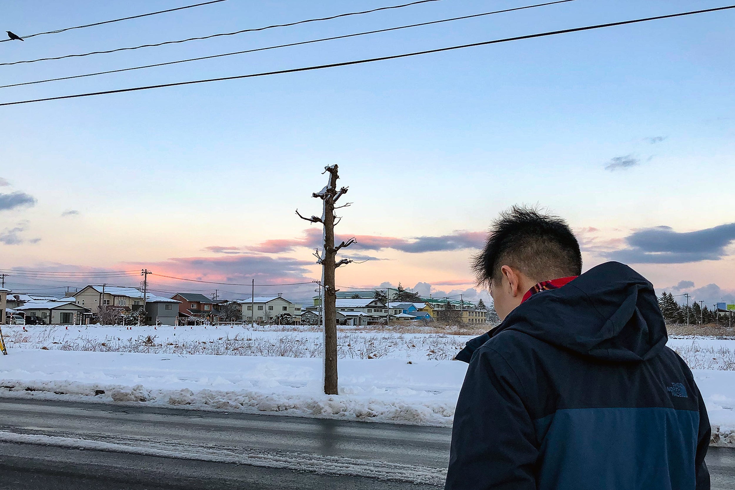 Elijah Suh walks through snow in Misawa, Japan.