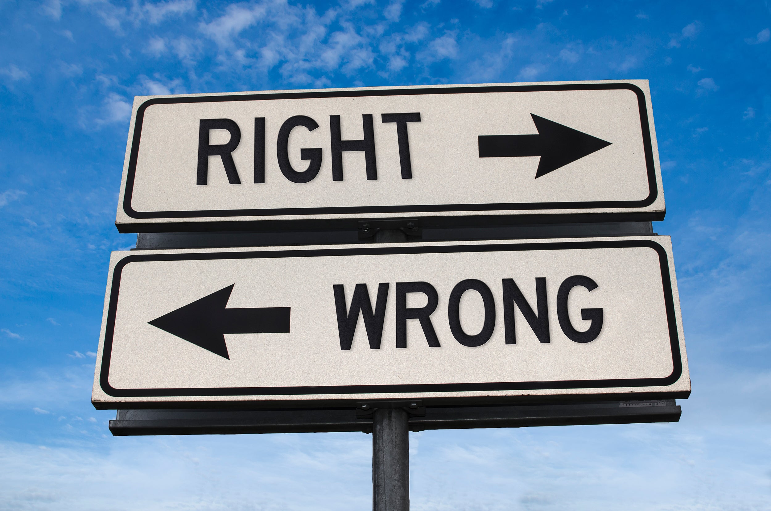 Photo illustration of "right" vs. "wrong" signposts pointing in opposite directions. (credit: Maria Vonotna/via iStock)