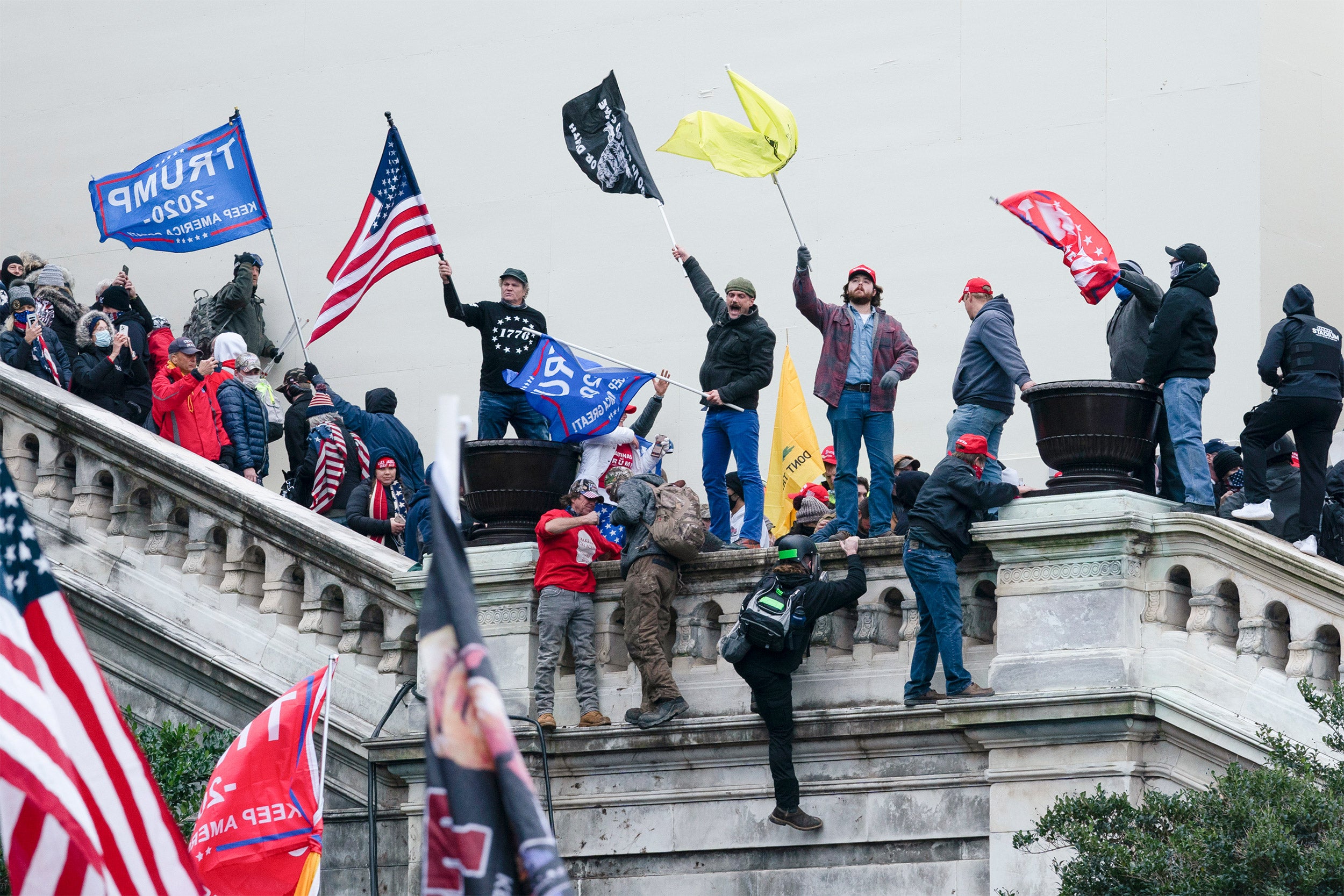 Rioters wave flags on the West Front of the U.S. Capitol in Washington on Jan. 6, 2021.
