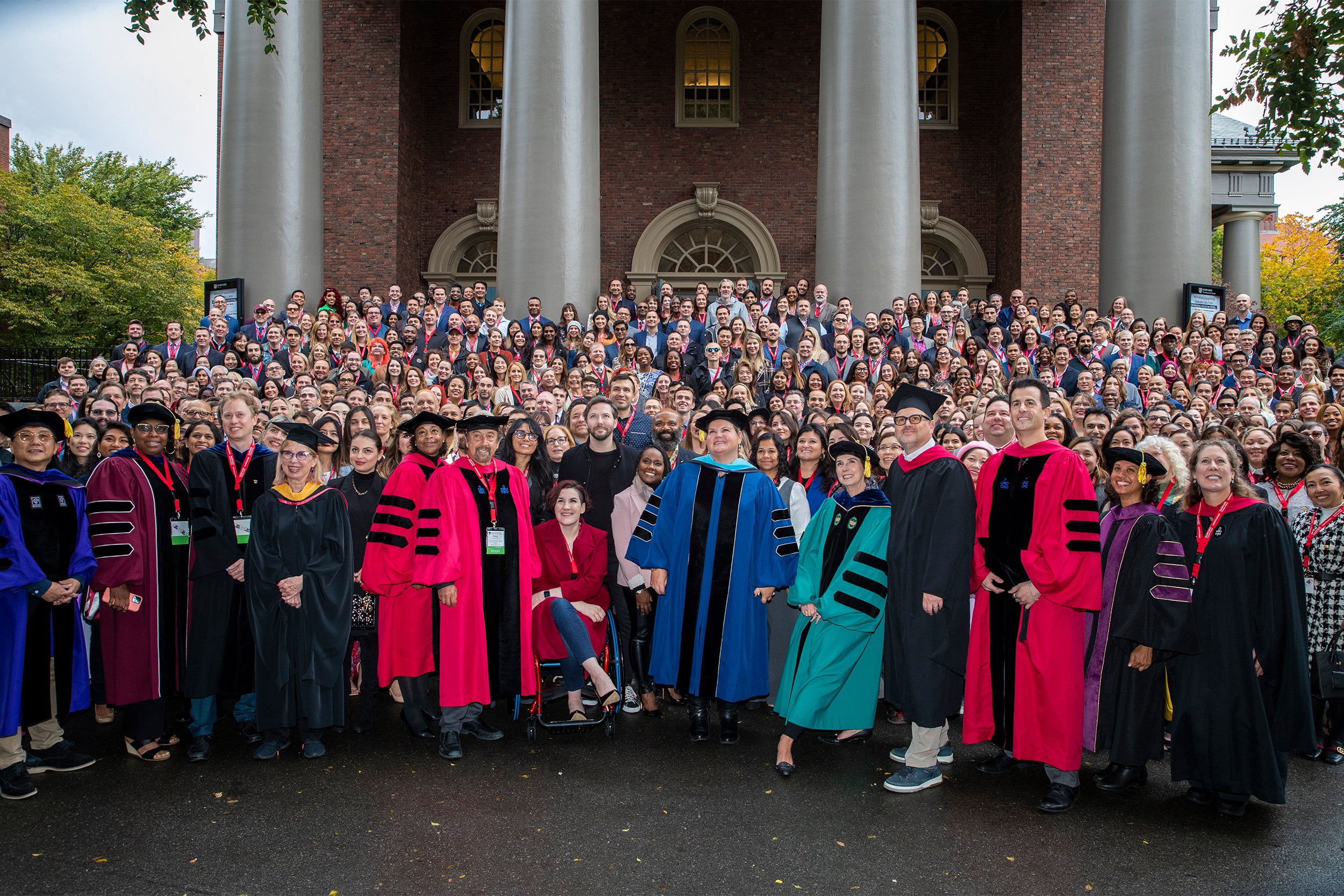 Harvard Extension School students and Deans pose for a group photo outside of Memorial Church before their convocation ceremony.