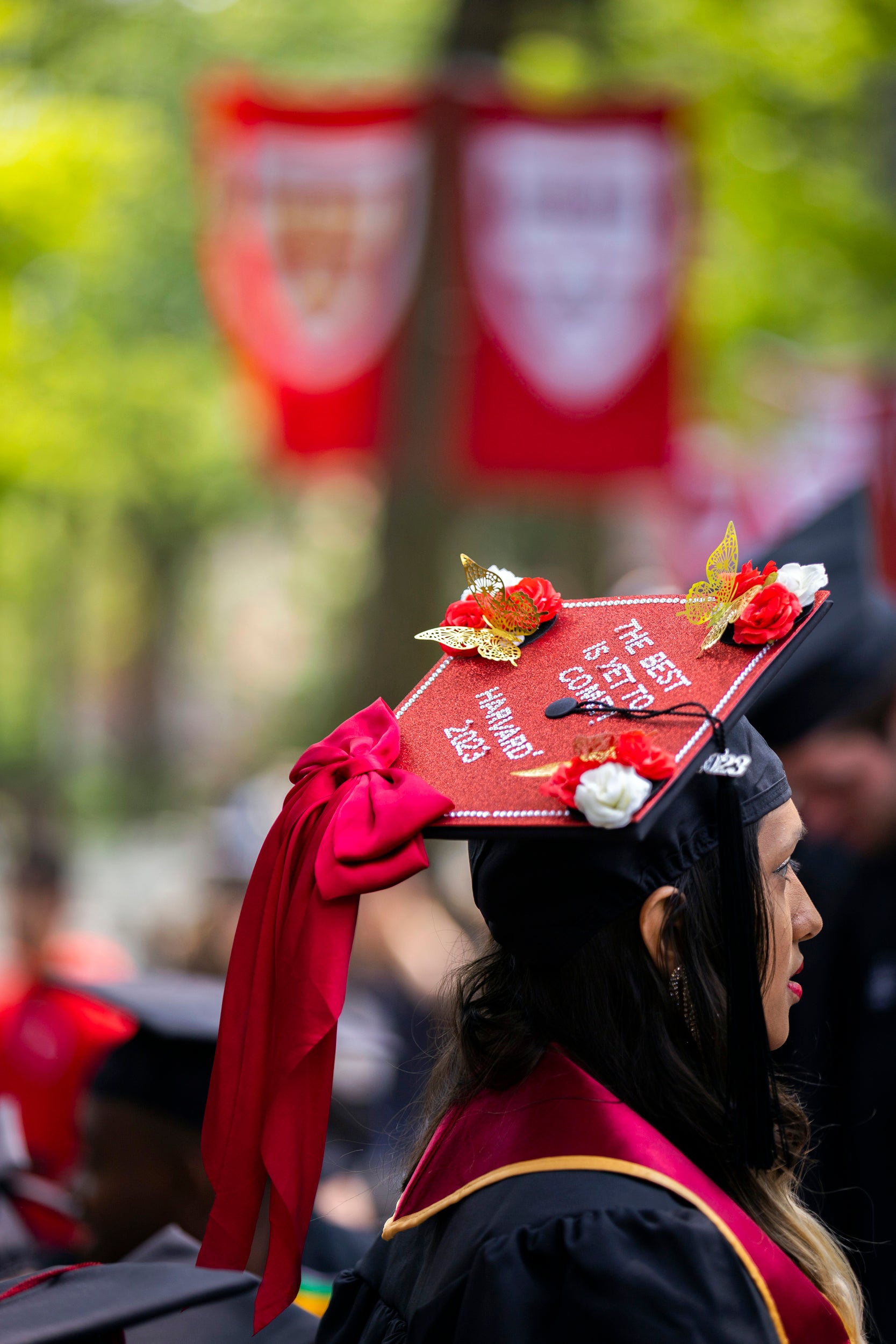 Nisha Sayed wears decorated mortarboard reading "The best is yet to come!"