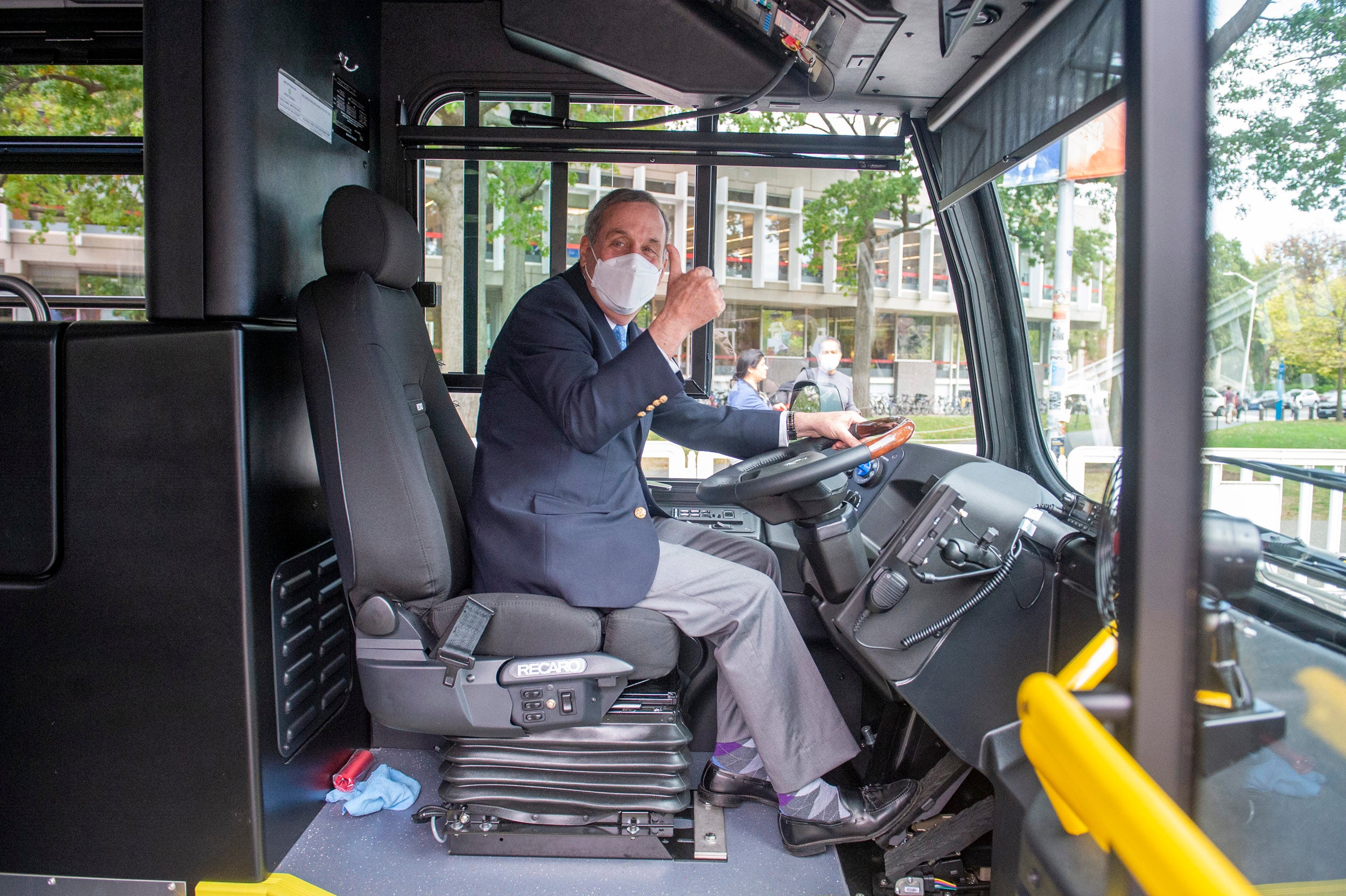 When Harvard unveiled a fleet of electric buses in October 2021, Bacow sat behind the wheel and