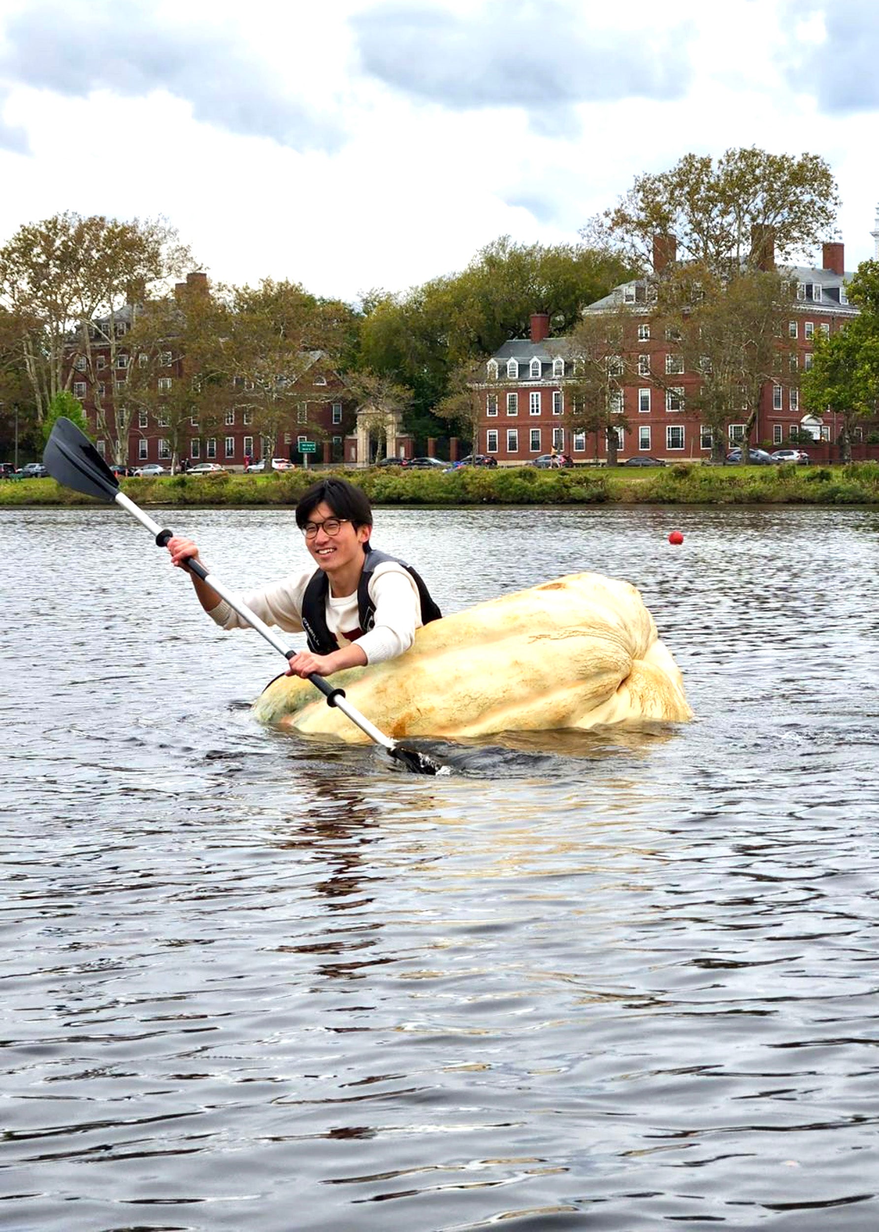 Senior crosses Charles River in giant pumpkin — Harvard Gazette
