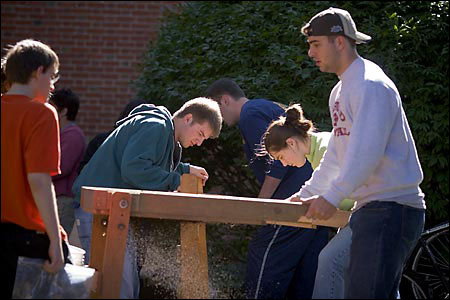 students digging outside Mass