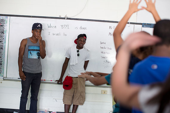 Counselors Jaydee Flemmings (left) and Maldini Bantefa observe the rehearsal.