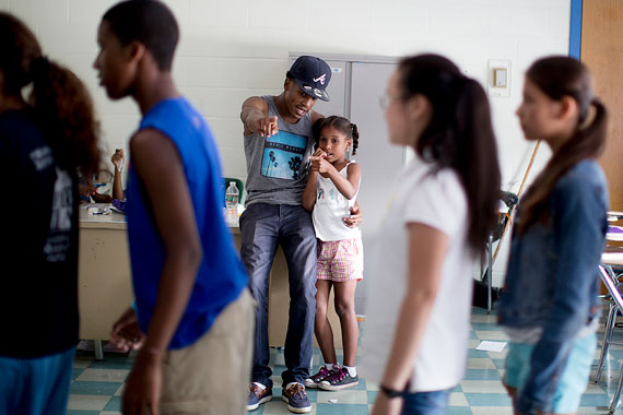 Yamilet Peguero, 9, originally from the Dominican Republic, gets some encouragement with a difficult dance step from Jaydee Flemmings.
