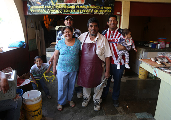 Ramon Mendoza (center) with his family at the fish market stand he founded in Chapala, Mexico. 