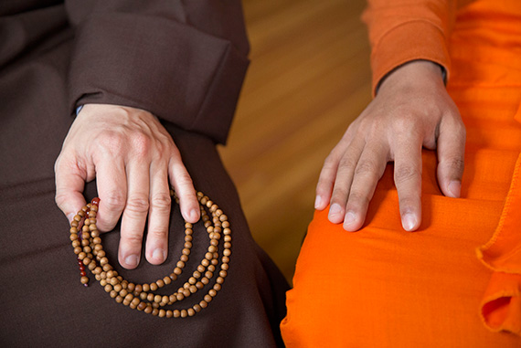 The hands of Priya Rakkhit Sraman, a Buddhist monk from Bangladesh, and Seng Yen Yeap (holding beads), a monk from Hong Kong. Photos by Kris Snibbe/Harvard Staff Photographer
