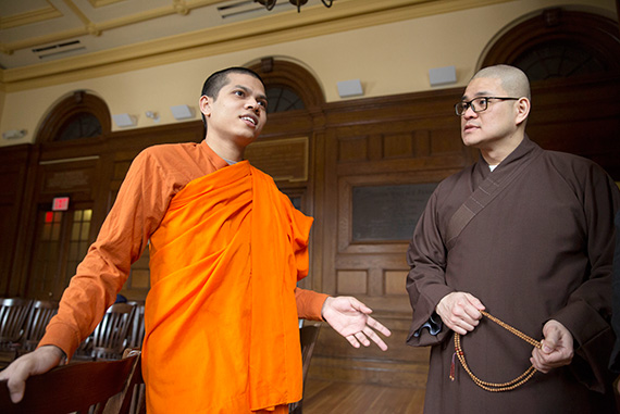 Priya Rakkhit Sraman (left), a Buddhist monk from Bangladesh, speaks with Seng Yen Yeap (holding beads), a monk from Hong Kong.