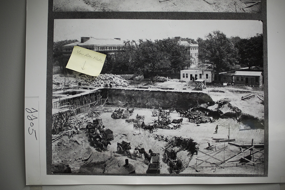 A 1913 photo of the Widener excavation, with a “You Are Here” sticker in the corner, hangs in Digital Imaging and Photography Services.