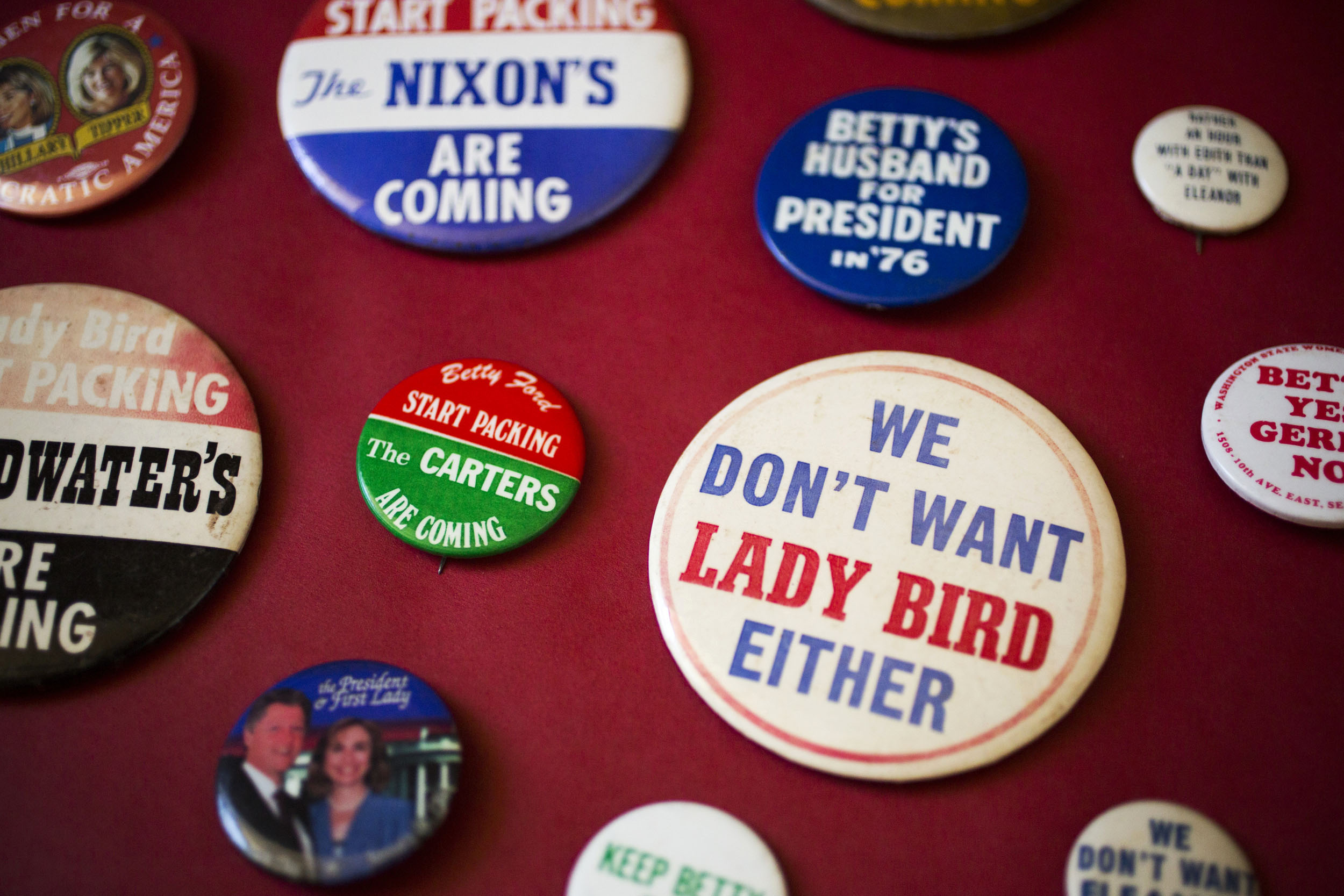 Campaign buttons feature candidate spouses.