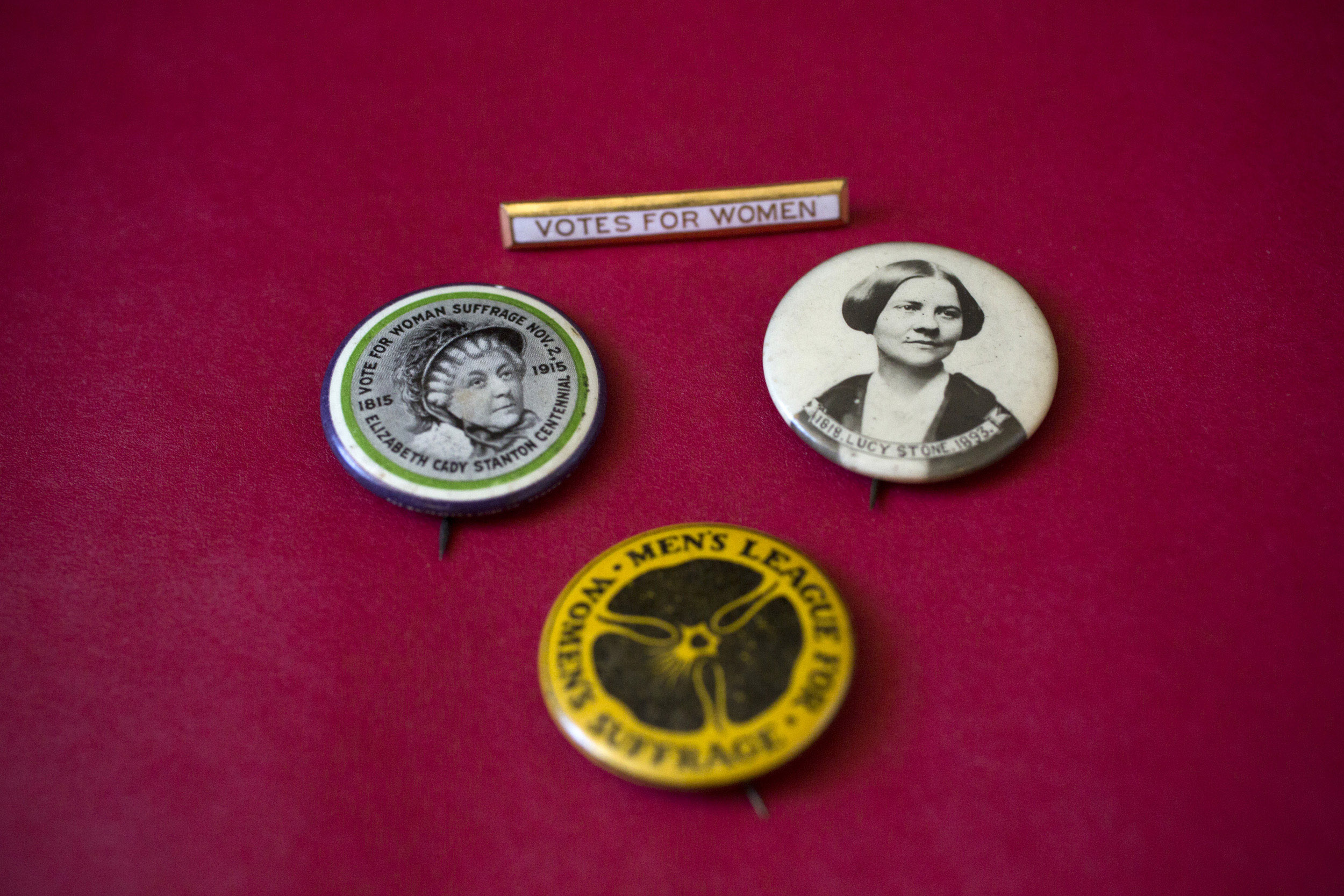 Women’s suffrage buttons show the likenesses of early suffragists Elizabeth Cady Stanton and Lucy Stone.