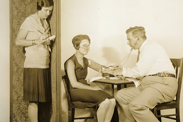 As mistress Olive Byrne takes notes, William Marston conducts an experiment. Courtesy of Schlesinger Library