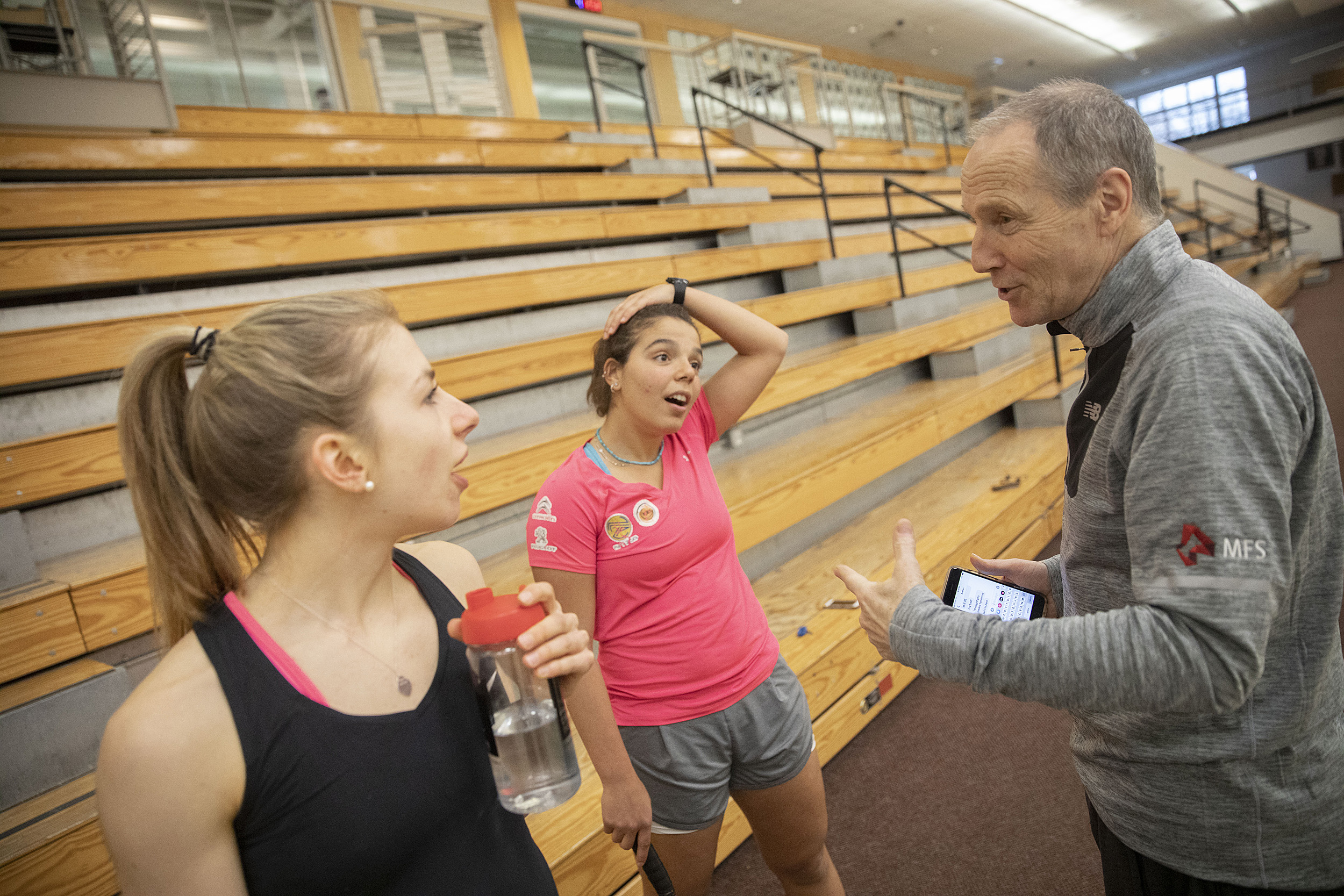 Amelia Henley and Amina Yousrytalk to coach Mike Way at the Murr Center.